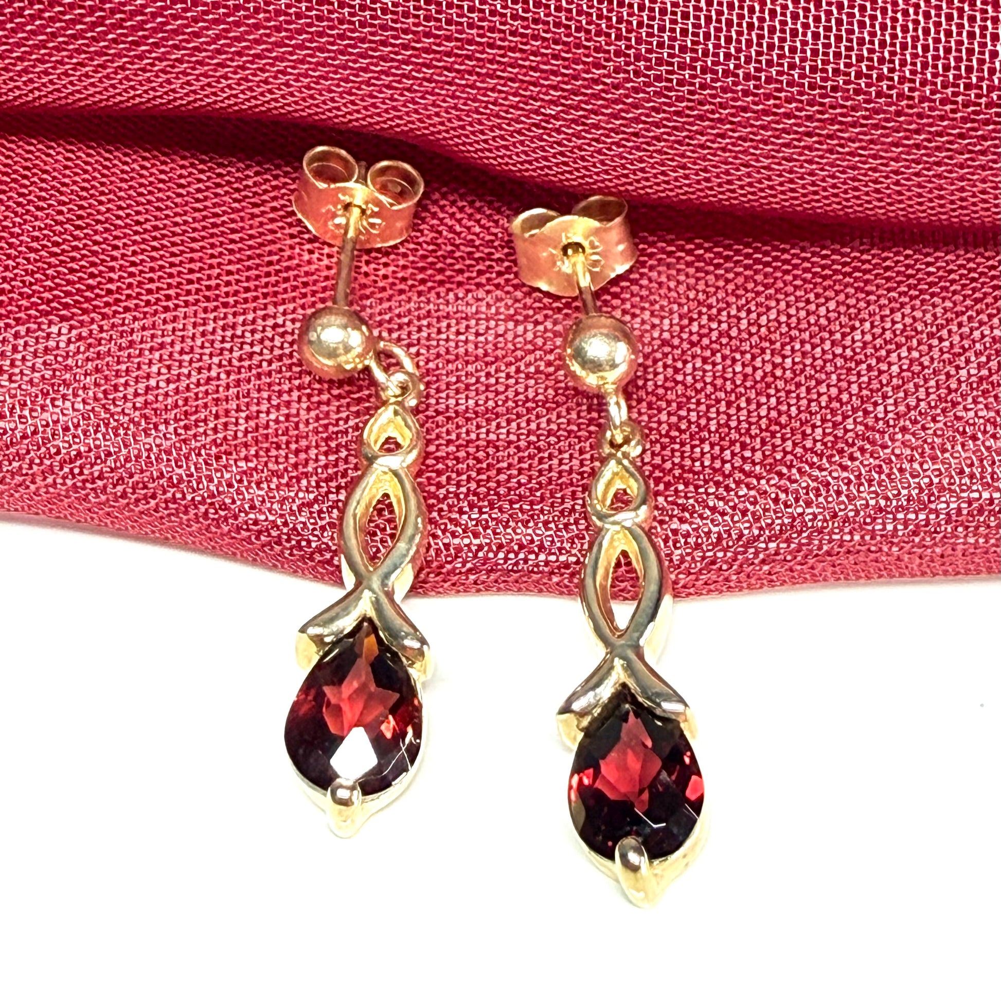 A pair of real red garnet drop earrings pear shaped yellow gold