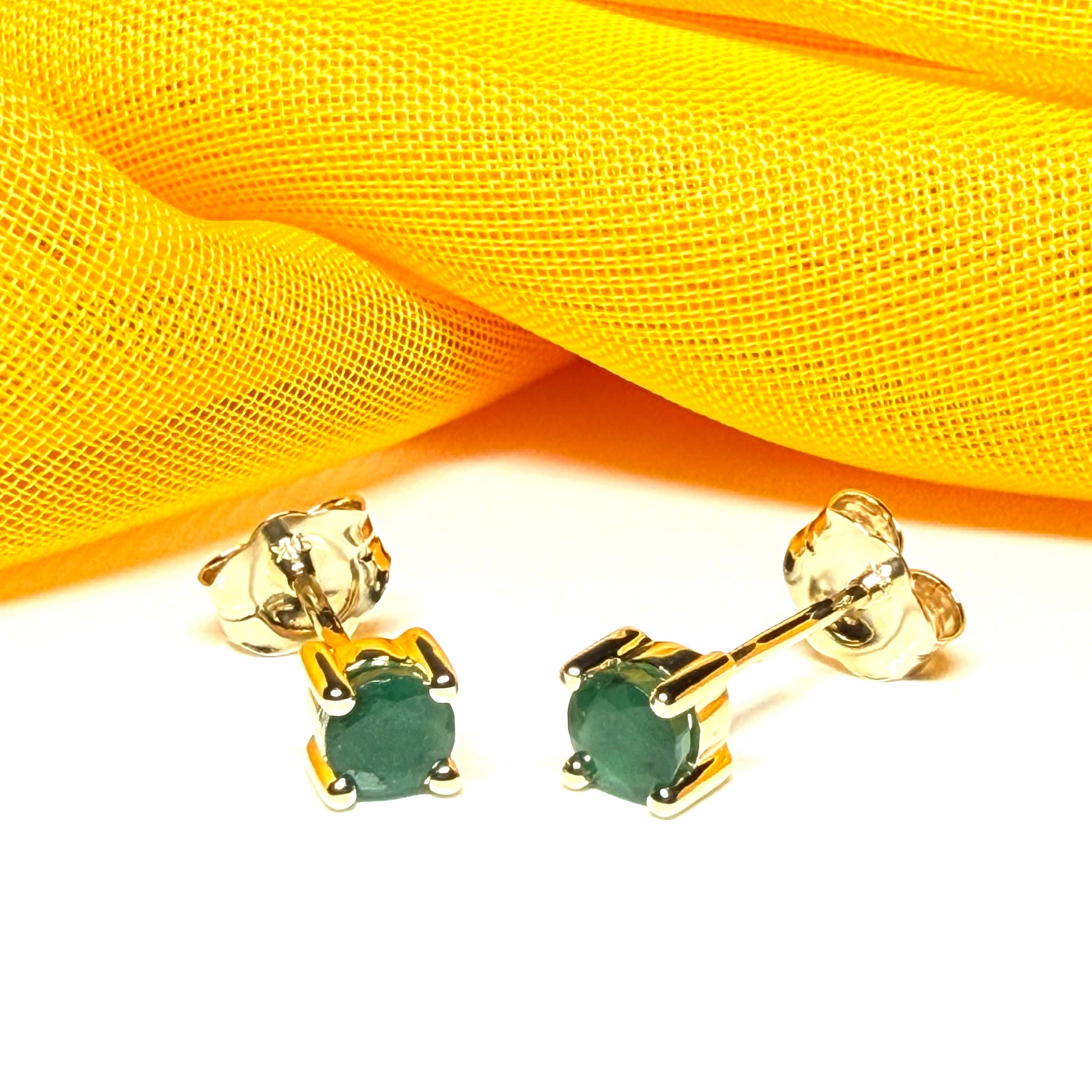 A pair of real ruby earrings round yellow gold claw set studs