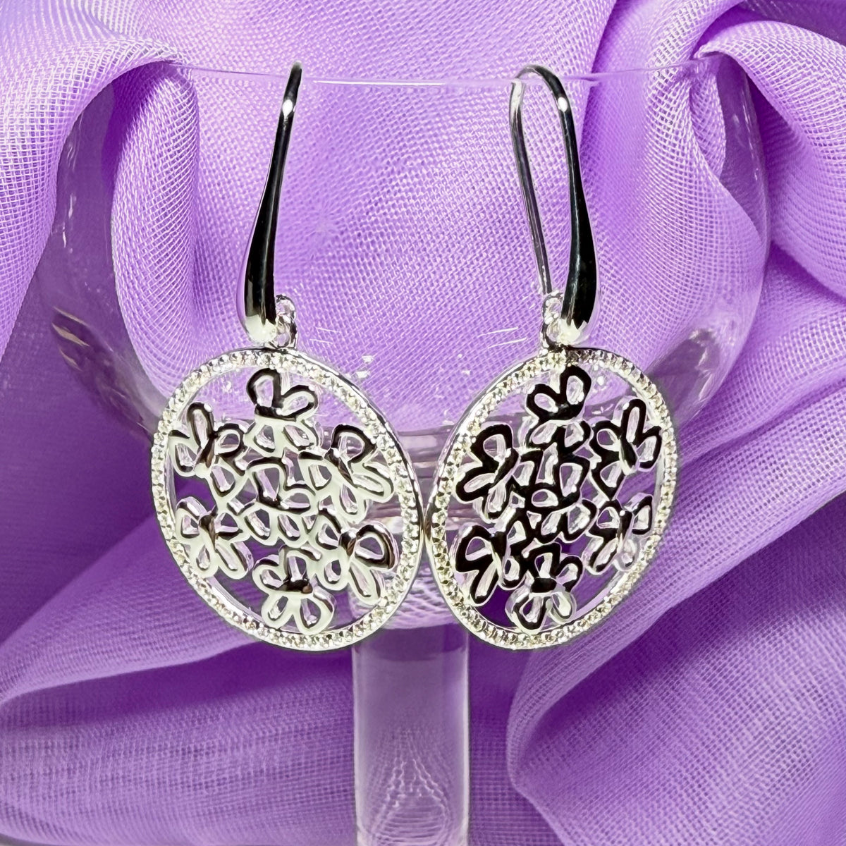 Sterling silver round shaped drop earrings with an open pierced design