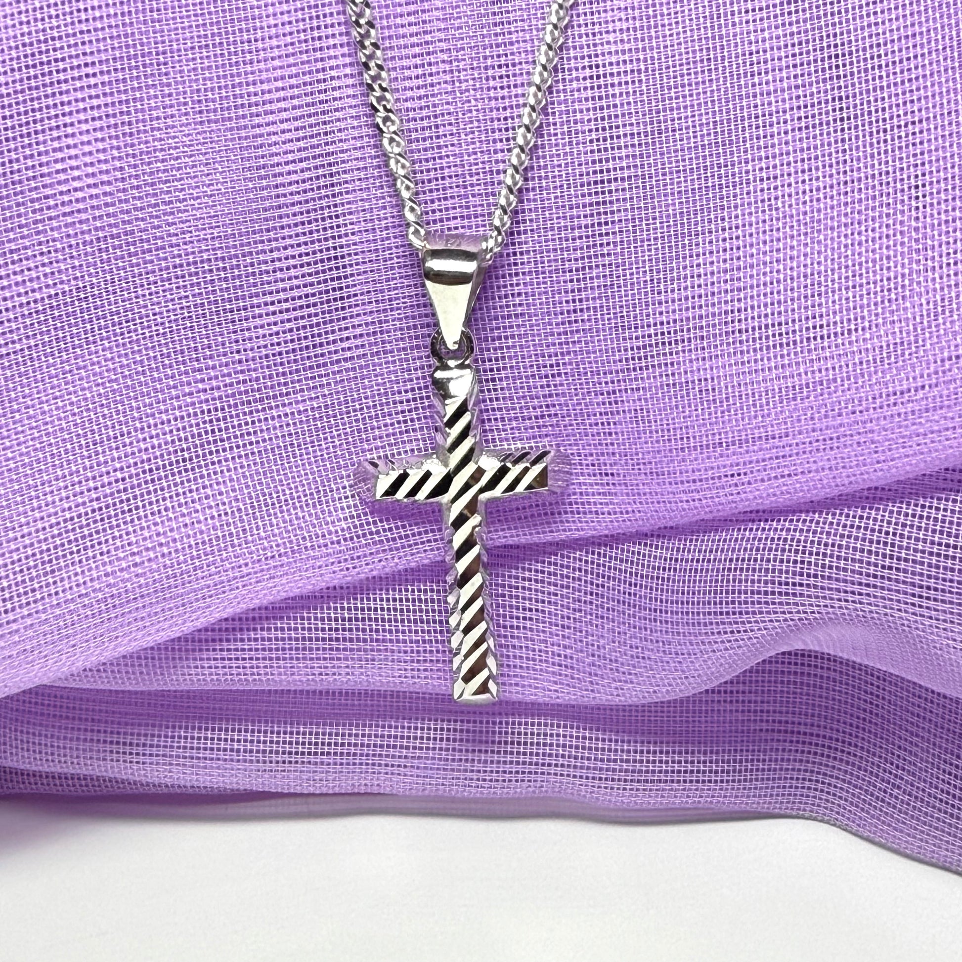 Diamond cut cross patterned sterling silver with a chain Included