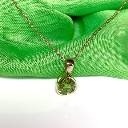 Pear peridot rubbed over yellow gold necklace