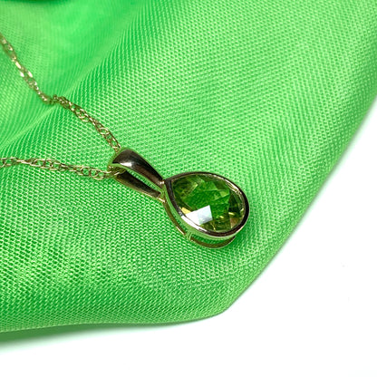 Pear peridot rubbed over yellow gold necklace