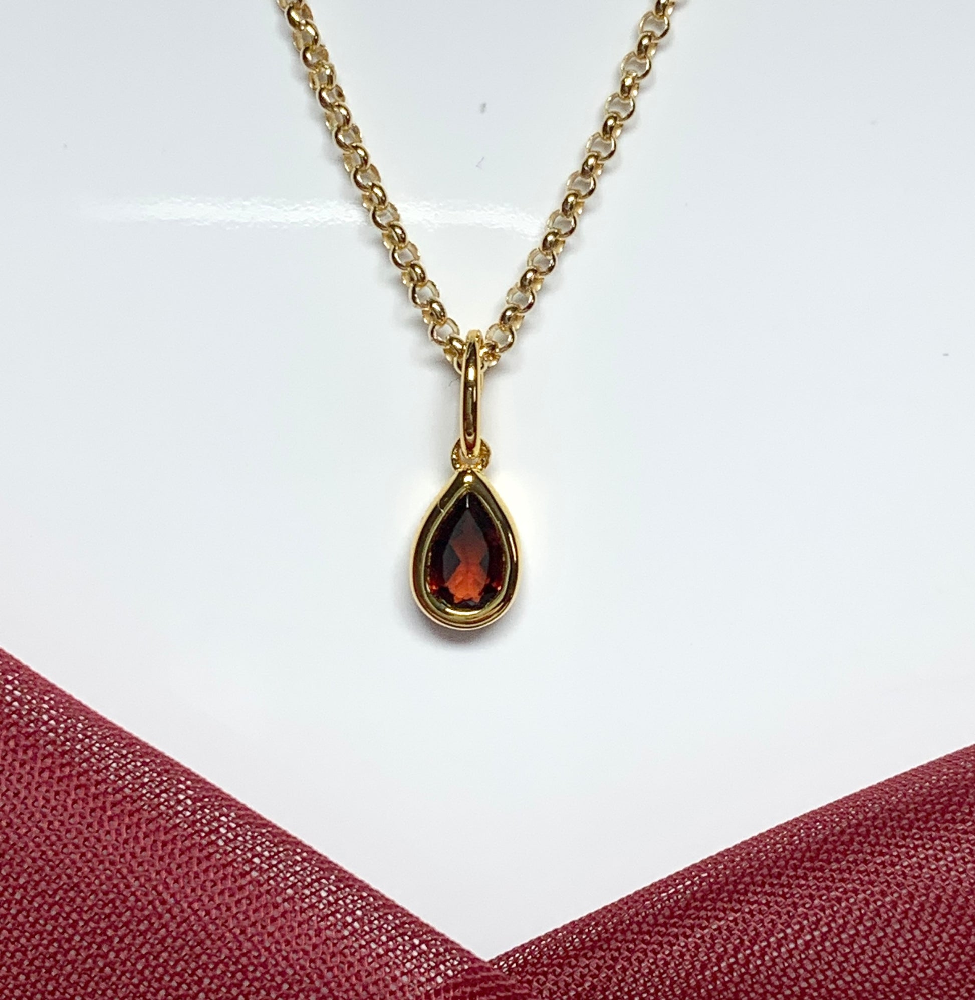 Pear shaped necklace set with a real red garnet stone sterling silver gilt including chain