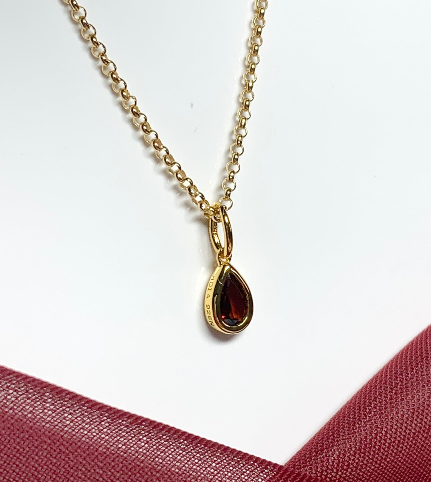 Pear shaped necklace set with a real red garnet stone sterling silver gilt including chain