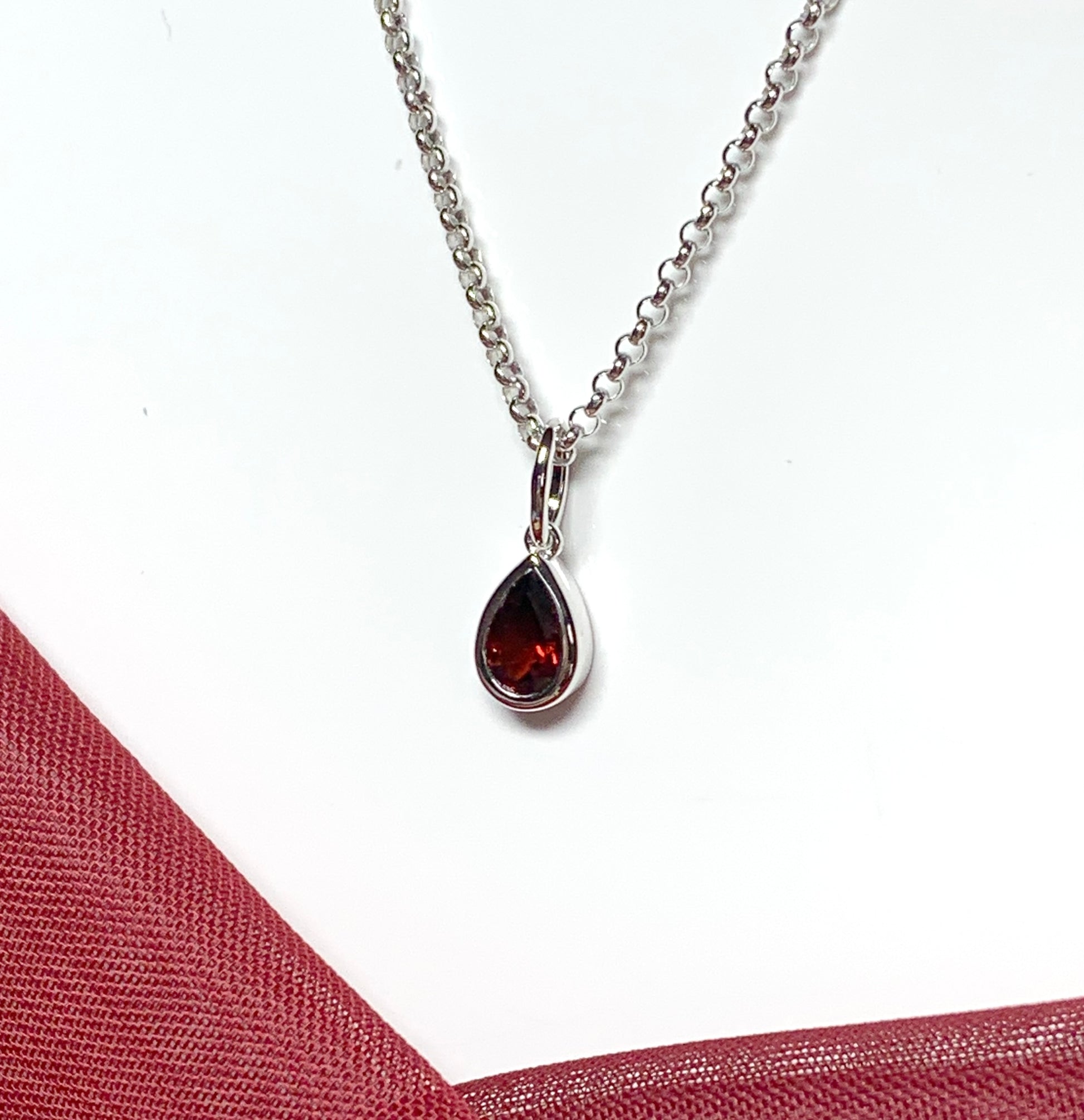 Pear shaped necklace set with a real red garnet stone sterling silver including chain