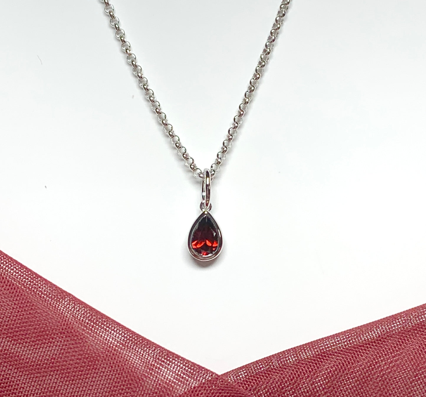 Pear shaped necklace set with a real red garnet stone sterling silver including chain