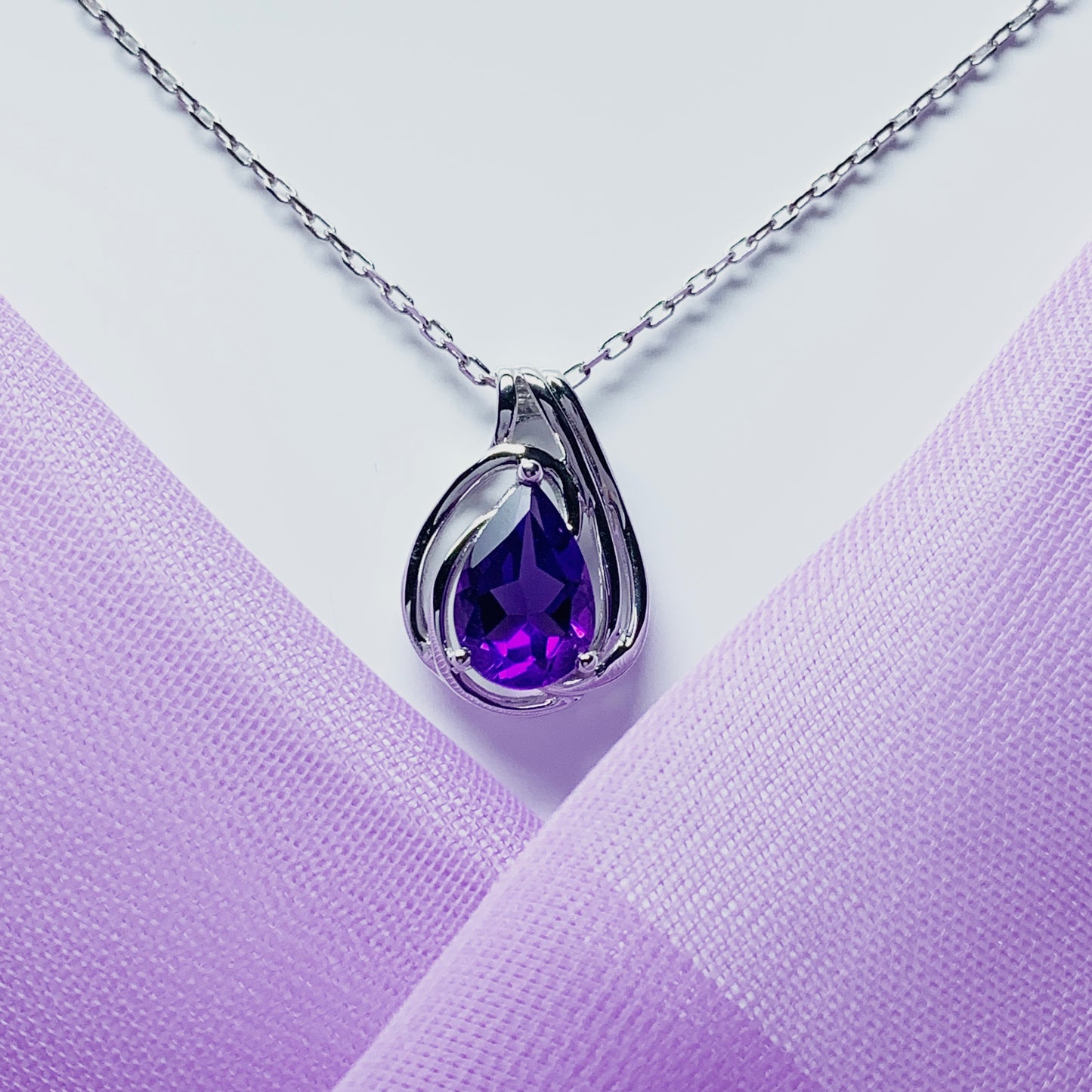 Pear shaped purple amethyst swirl mount white  gold necklace