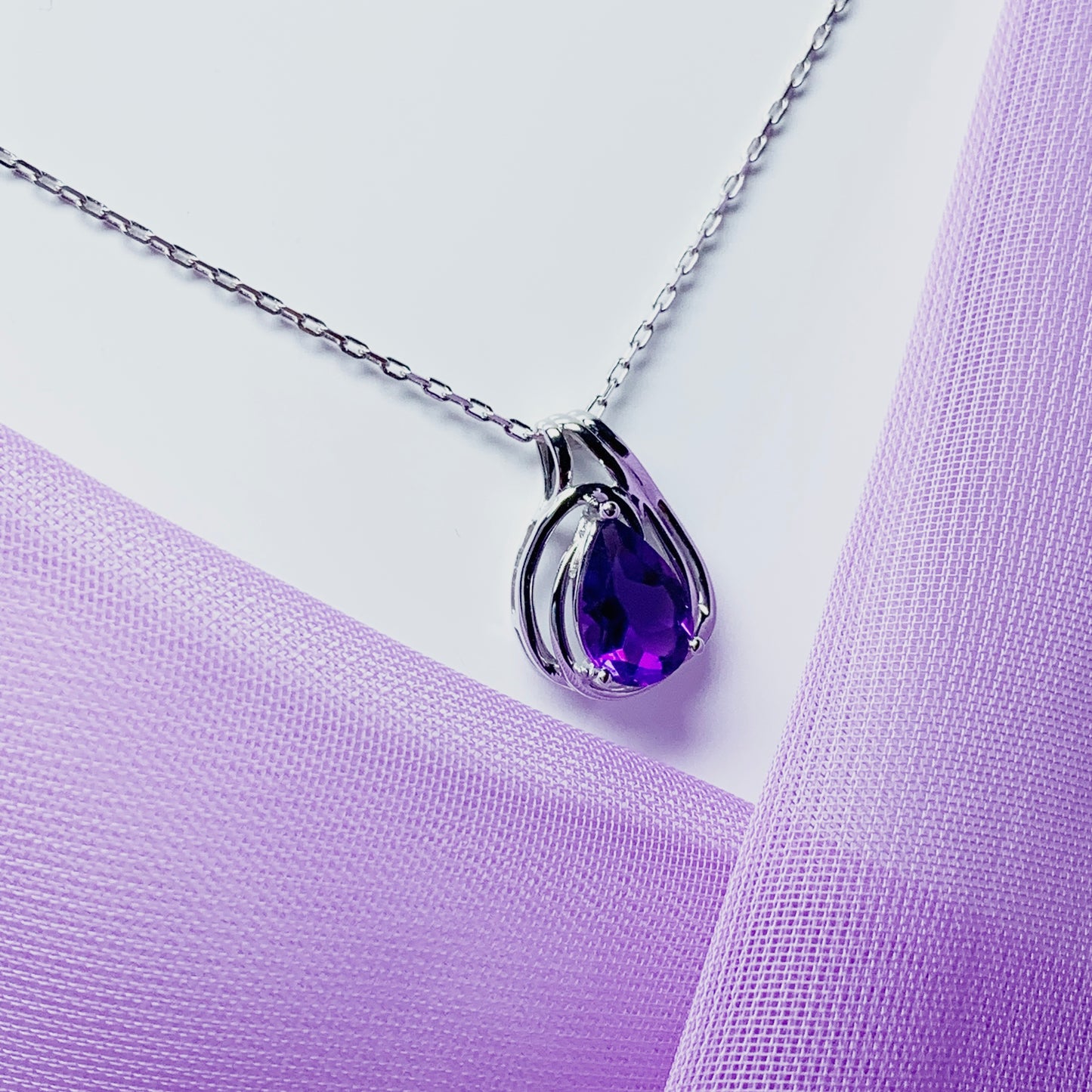 Pear shaped purple amethyst swirl mount white  gold necklace