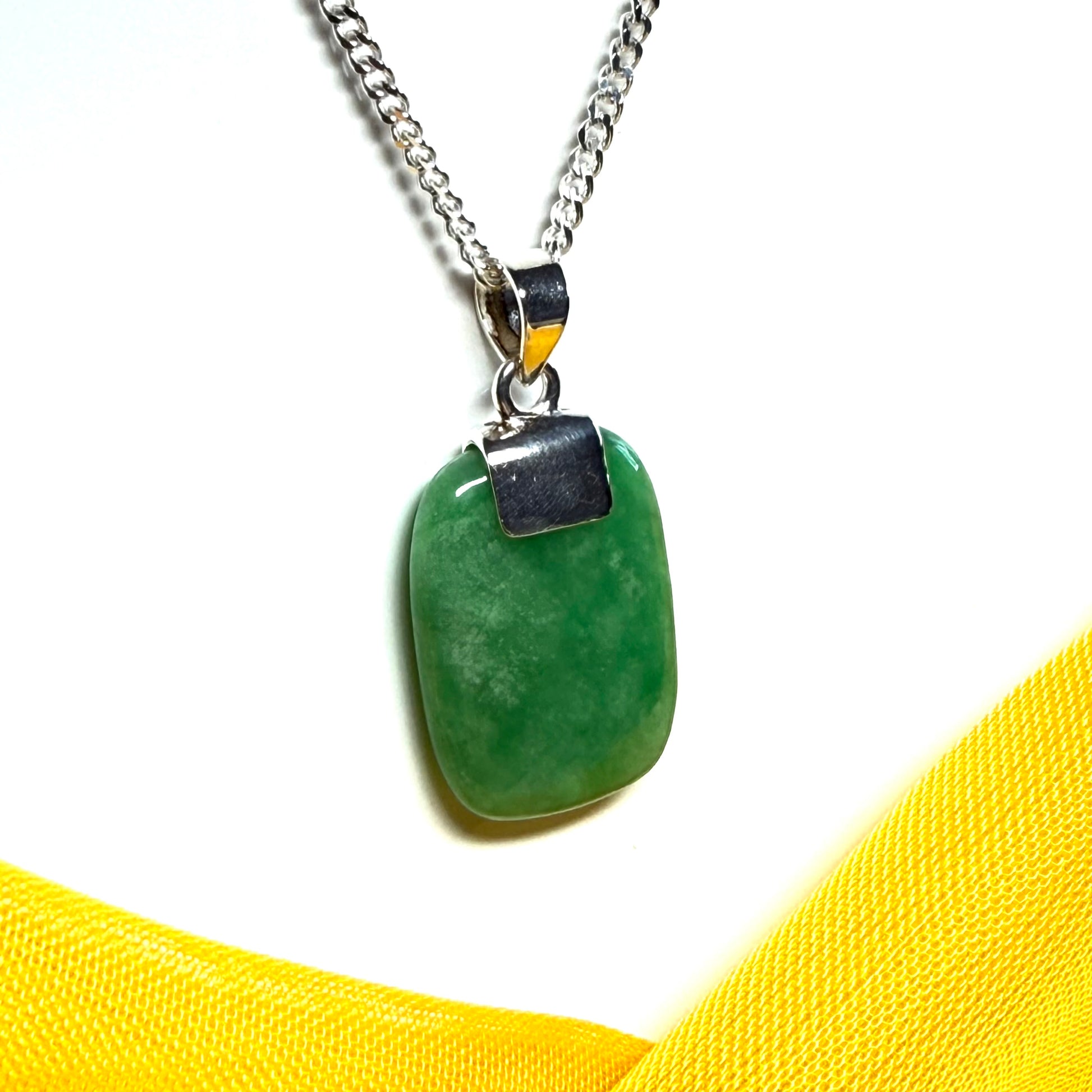 Necklace with a green pendant on a white background