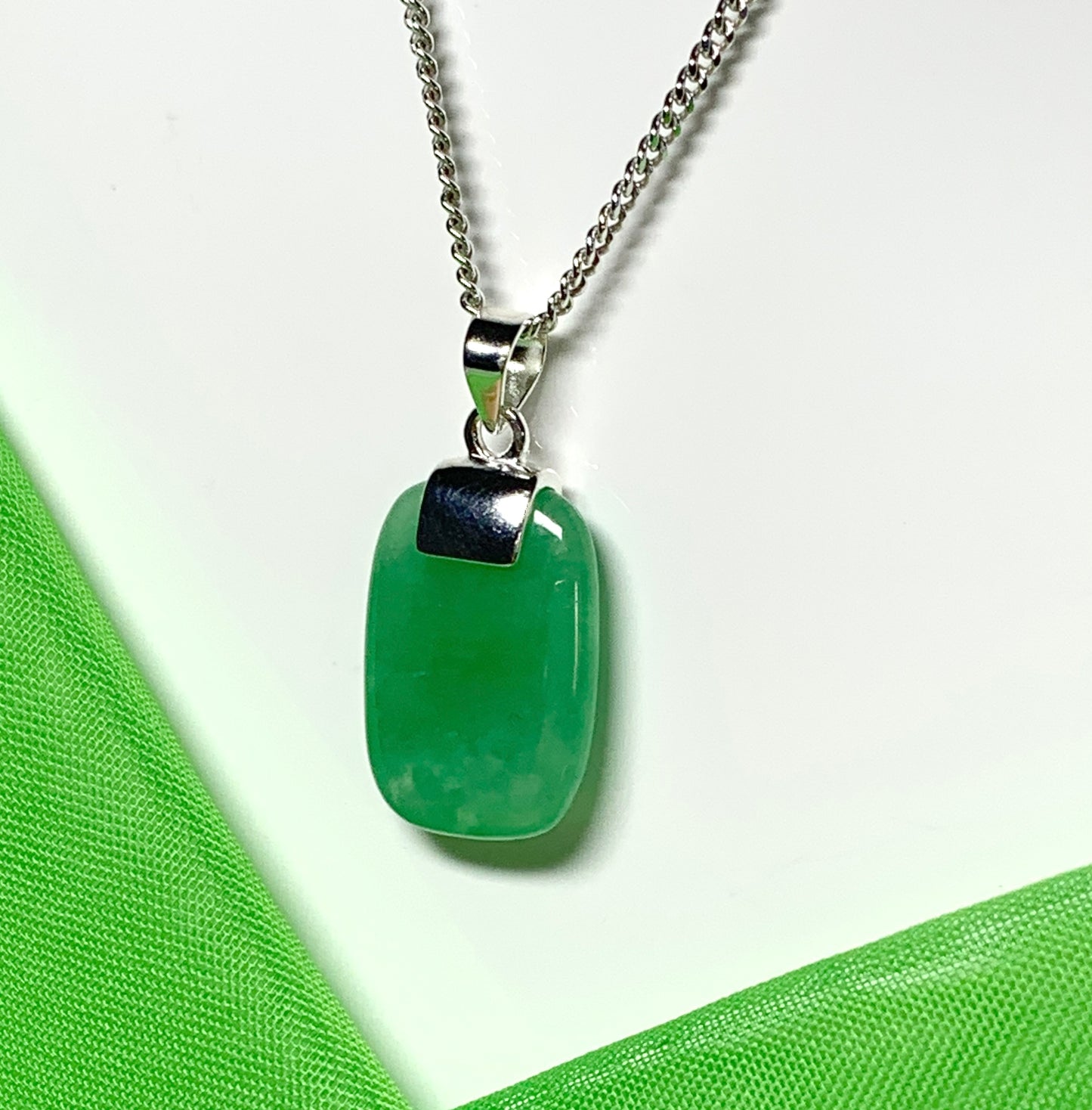 Pendant necklace having a real green jade sterling silver cushion shaped