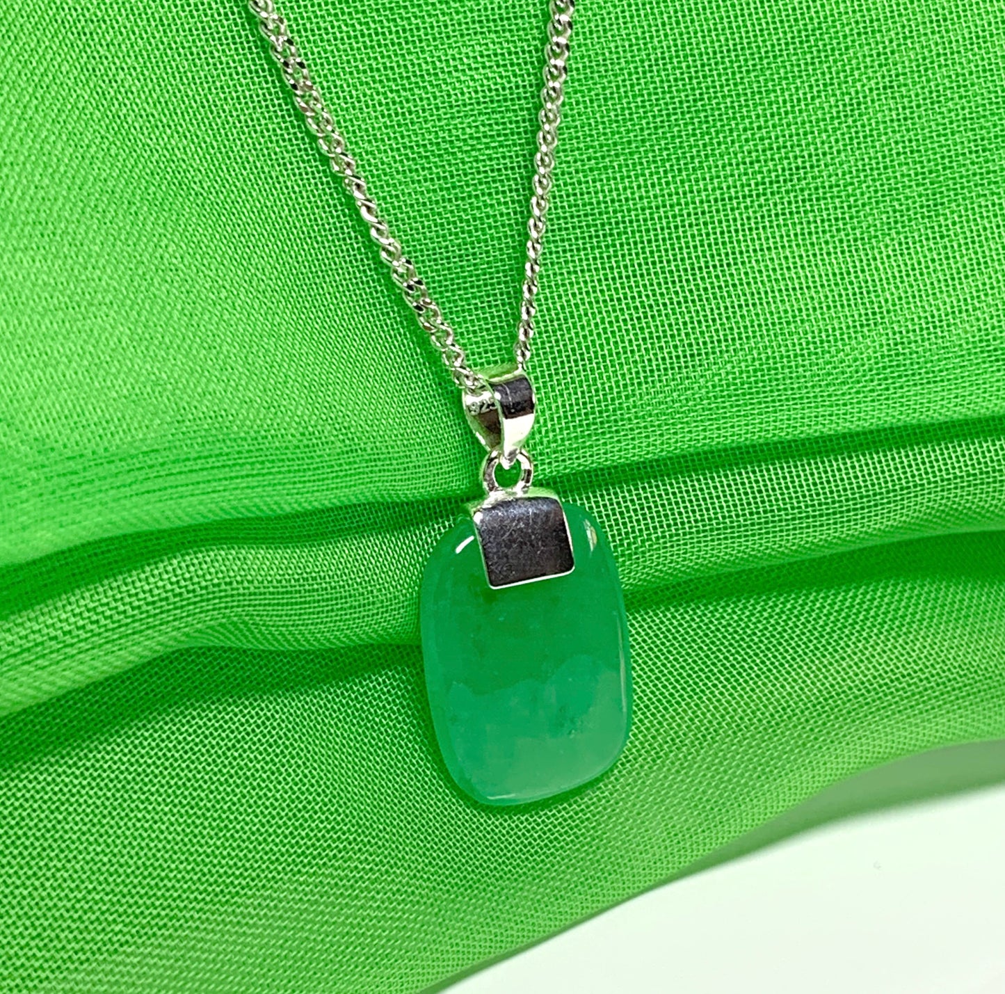 Pendant necklace having a real green jade sterling silver cushion shape