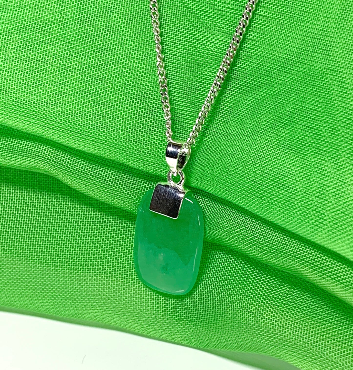 Pendant necklace having a real green jade sterling silver cushion shape