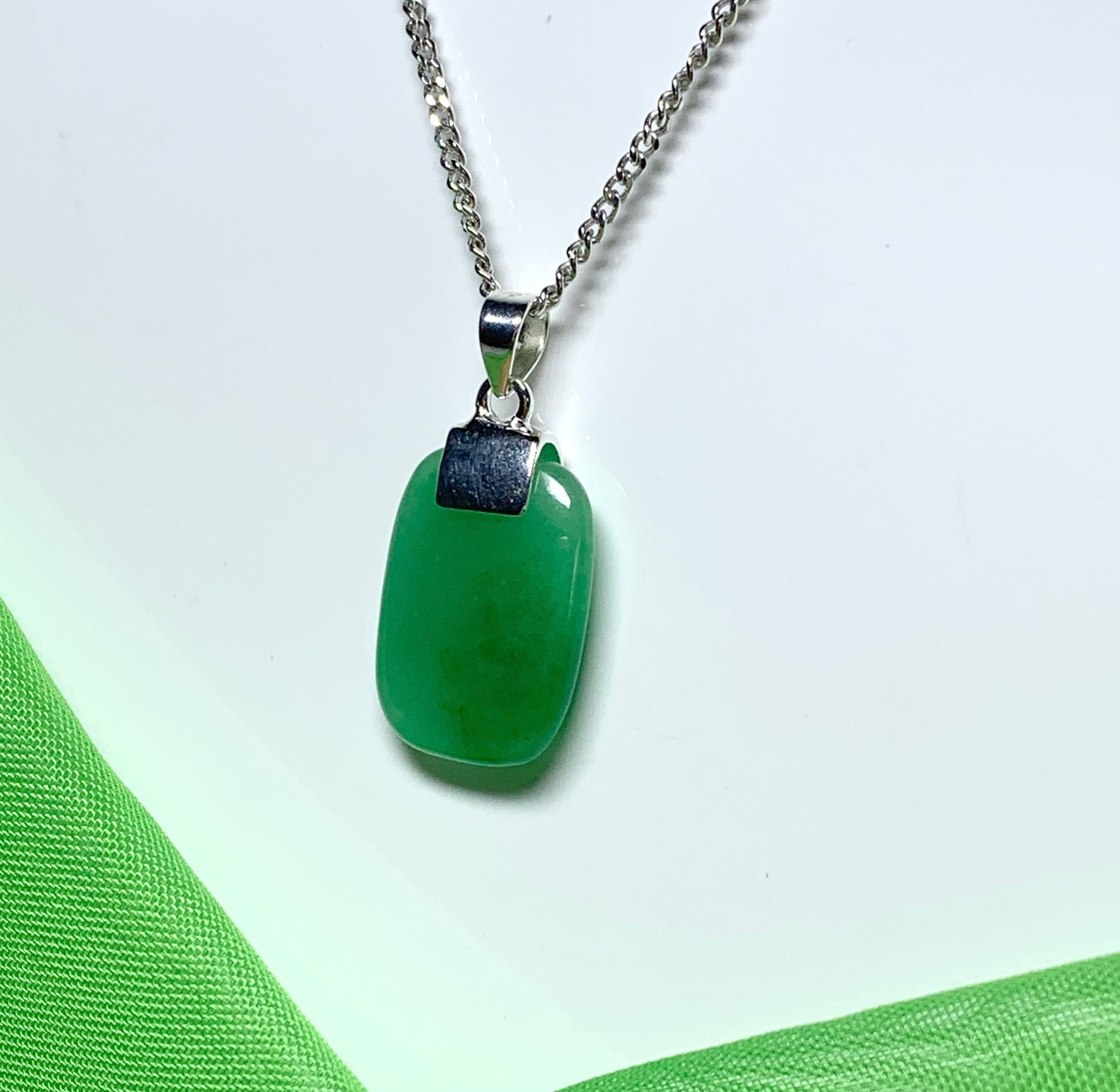 Pendant necklace having a real green jade stone sterling silver cushion shaped