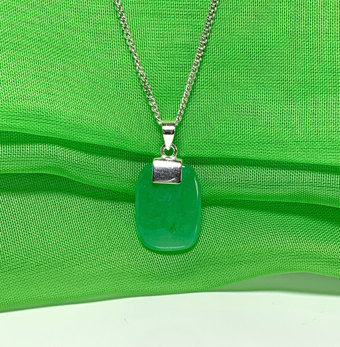 Pendant necklace having a real green jade sterling silver cushion shape