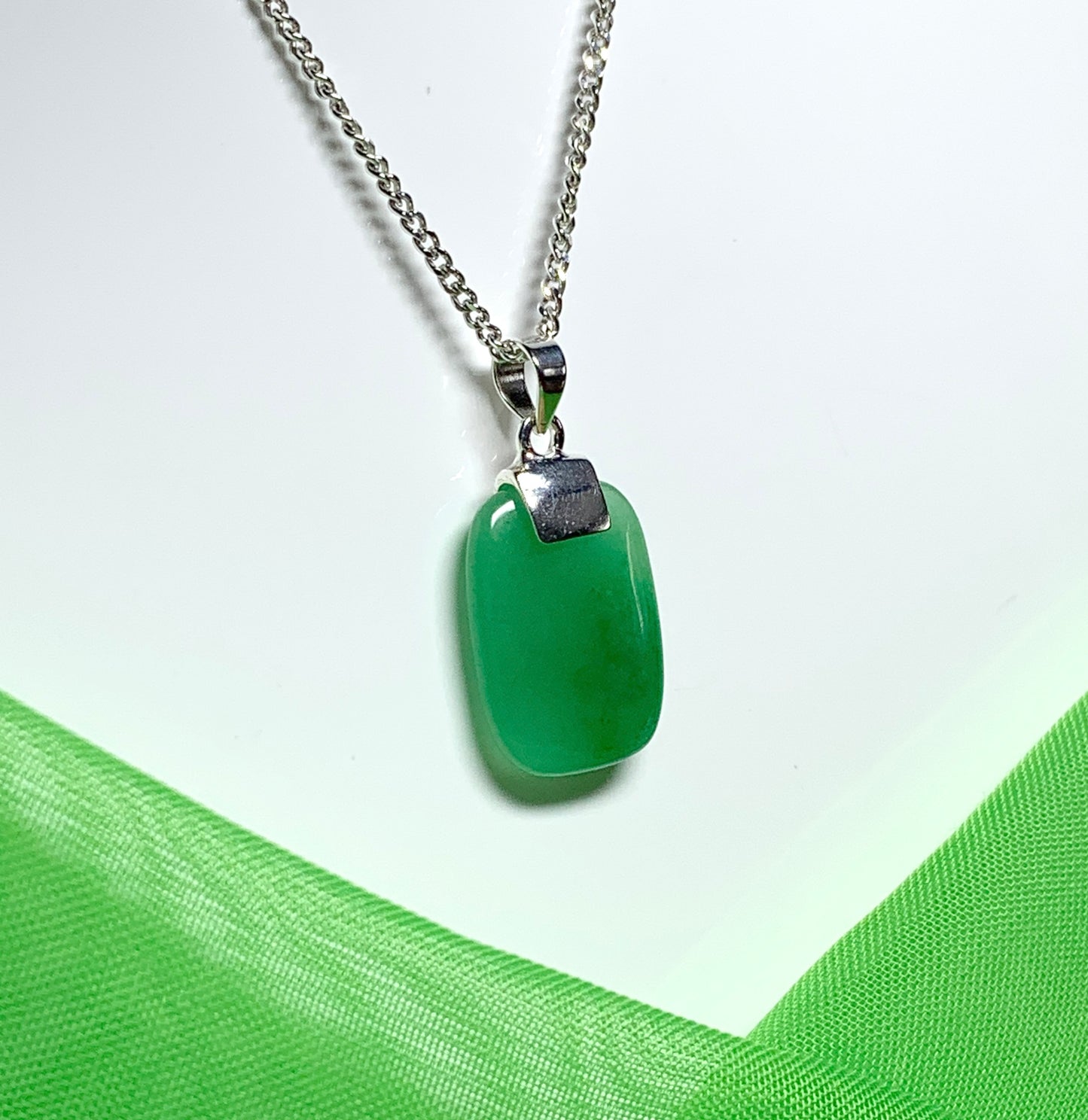 Pendant necklace having a real green jade stone sterling silver cushion shaped