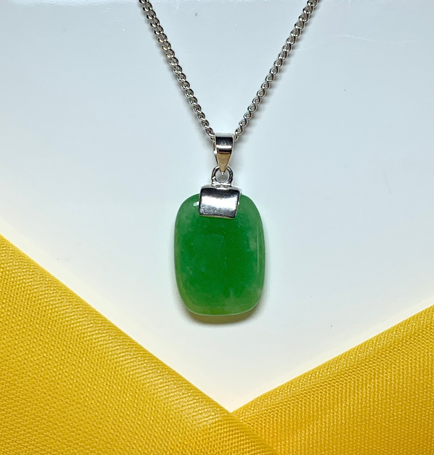 Pendant necklace with a real green lozenge jade stone sterling silver cushion shaped