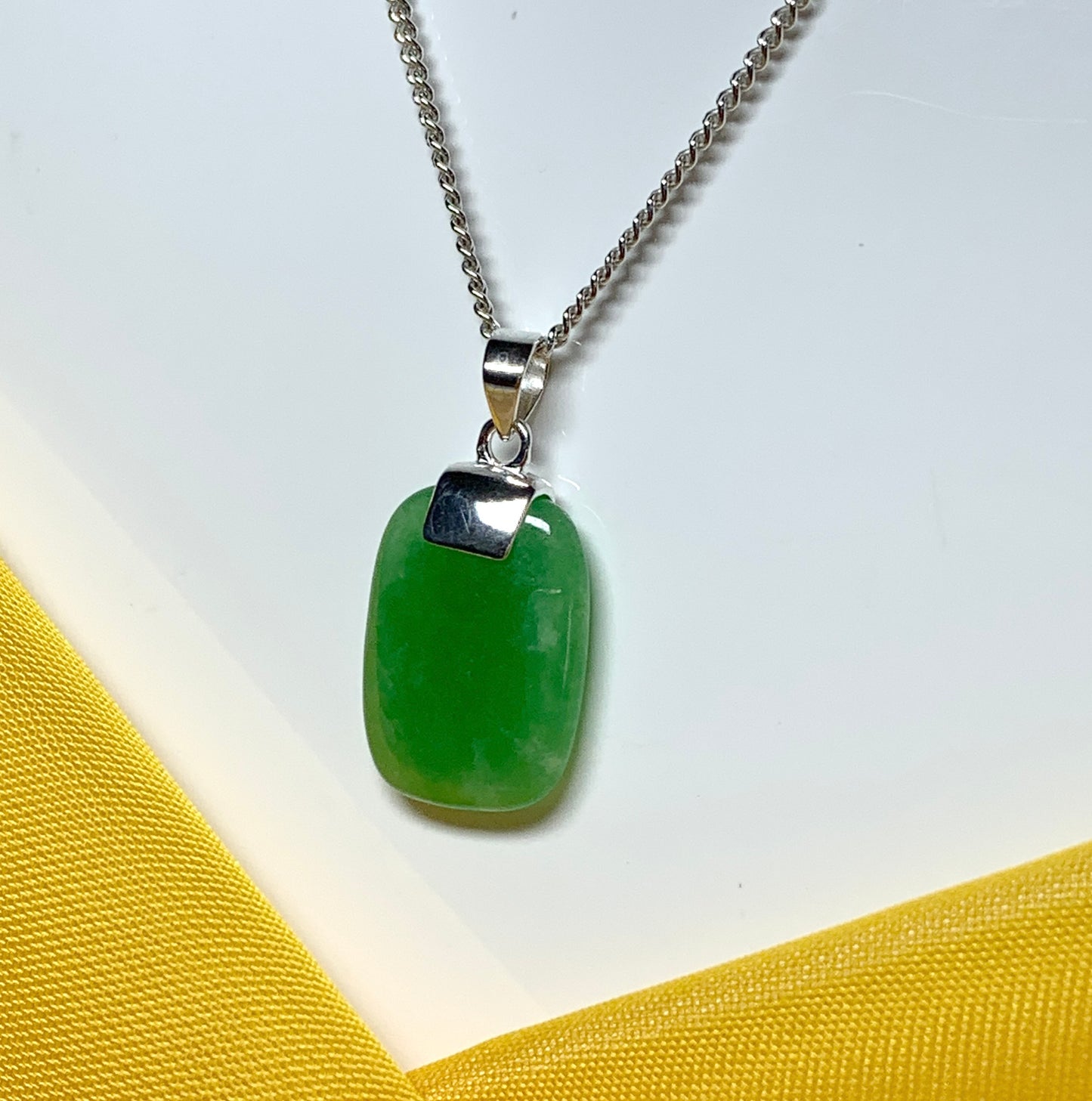 Pendant necklace with a real green lozenge jade stone sterling silver cushion shaped