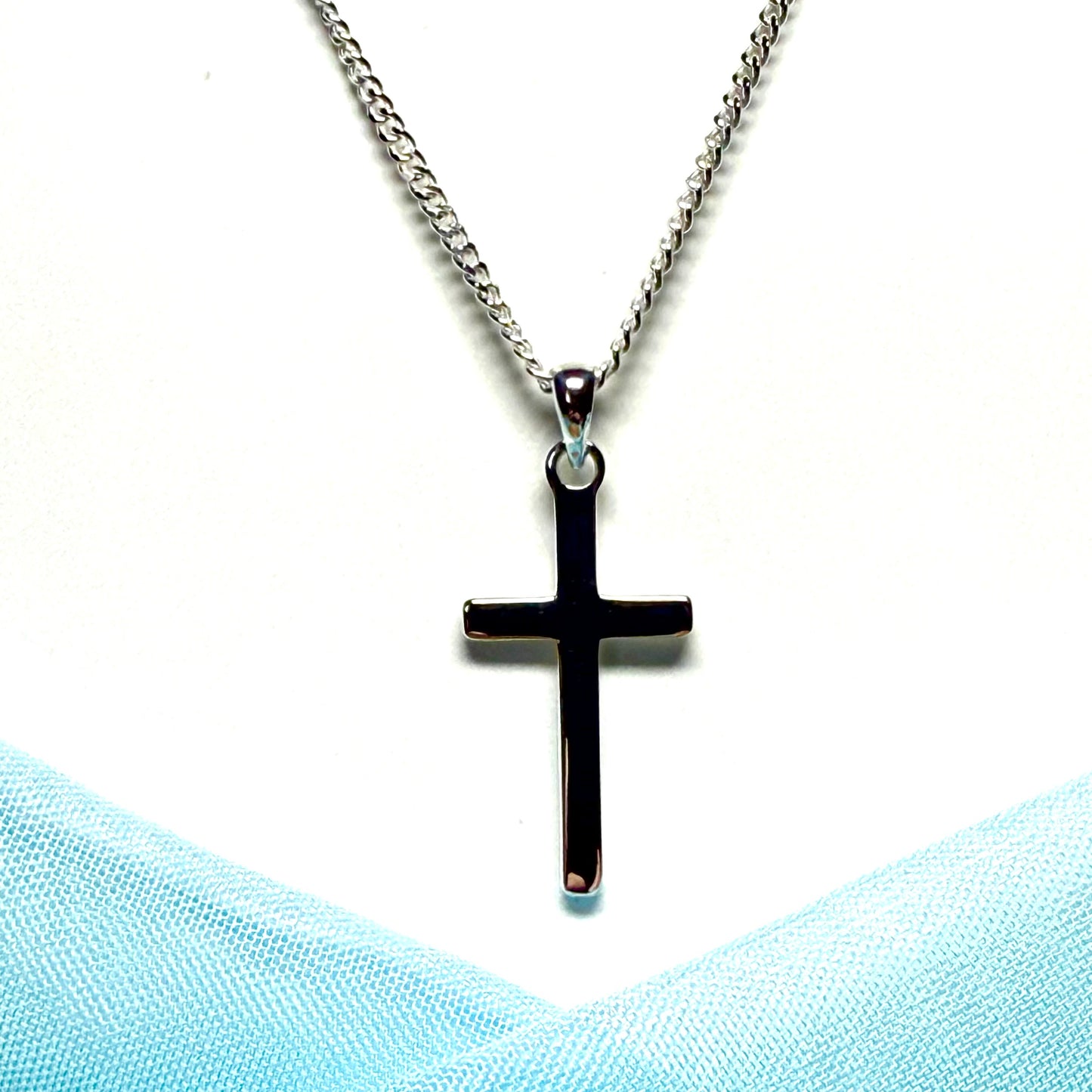 Polished plain solid sterling silver cross including a curb chain