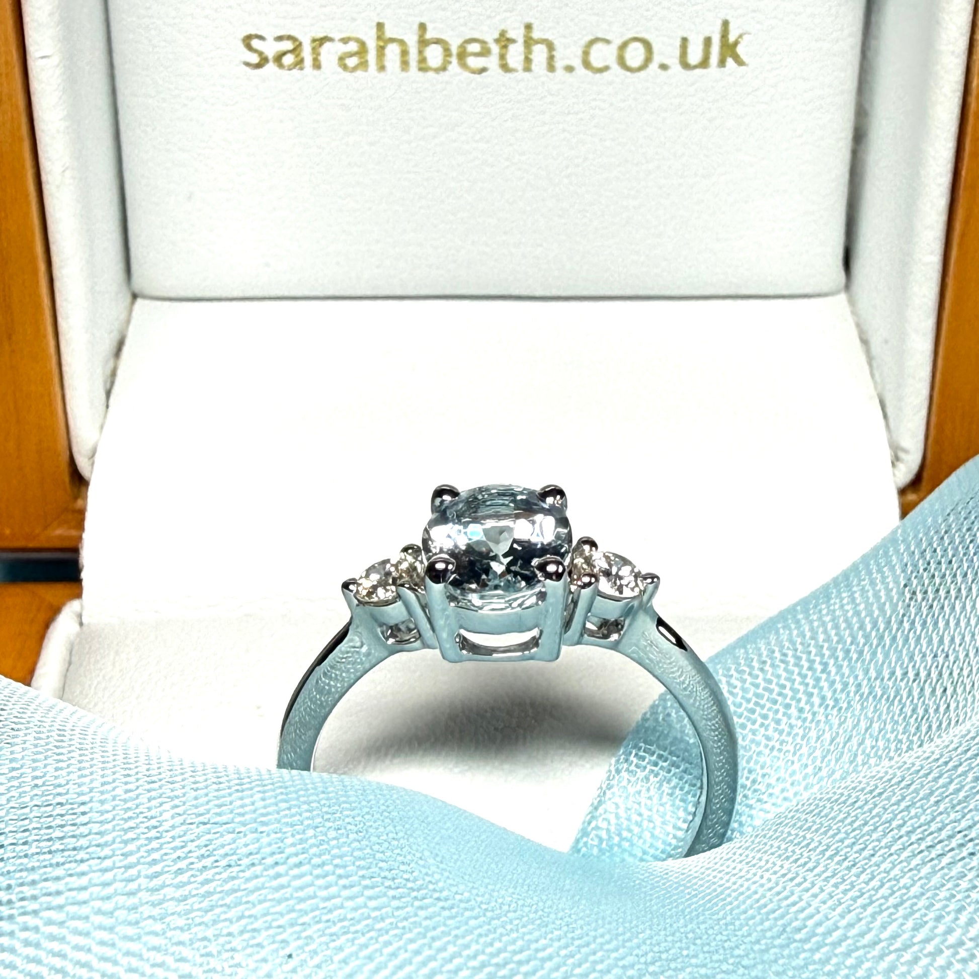 Real 1 carat aquamarine ring and diamond white gold fancy trilogy three stone dress side view