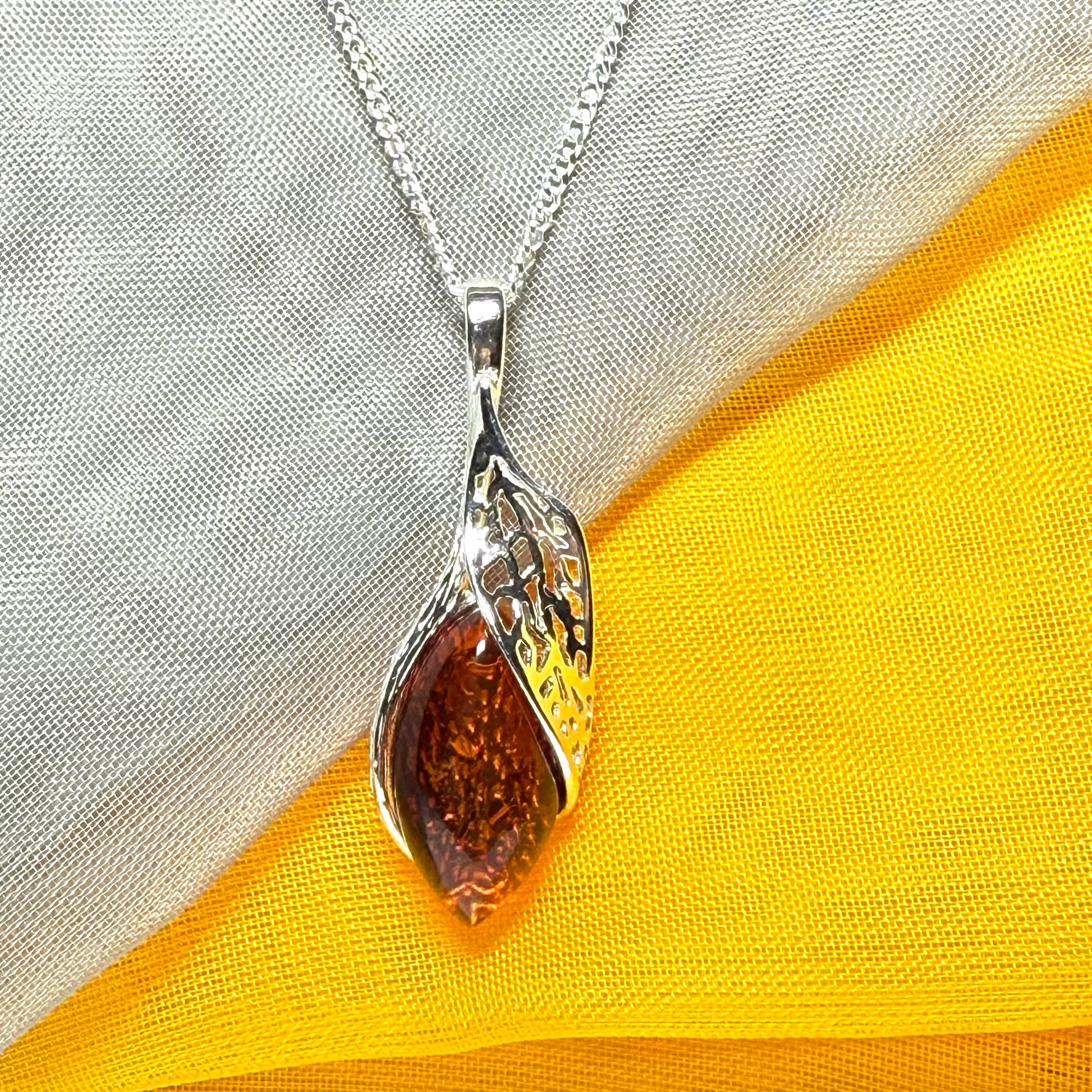 Real amber marquise sterling silver necklace with a swirl set fancy open pendant
