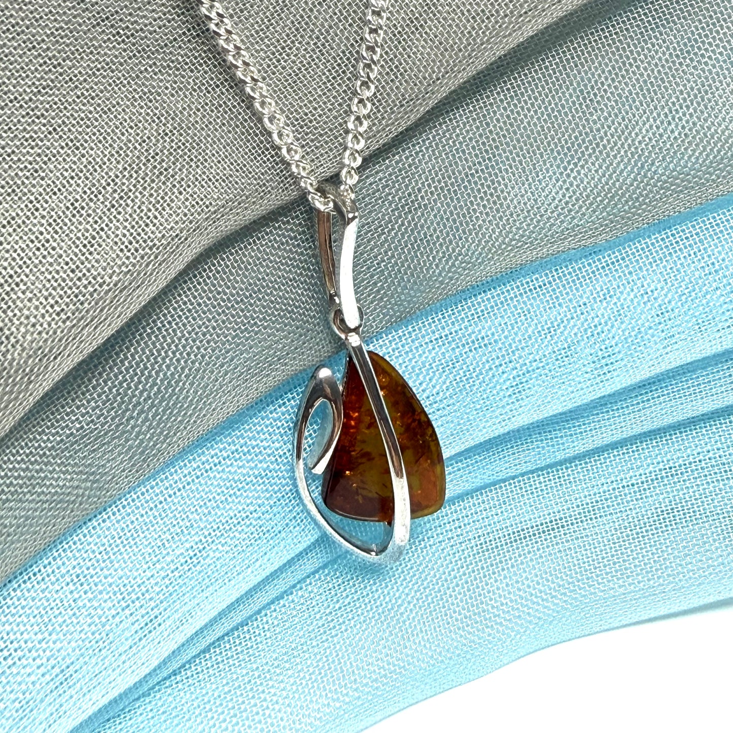 A real amber necklace sterling silver fancy open triangle shaped amber pendant