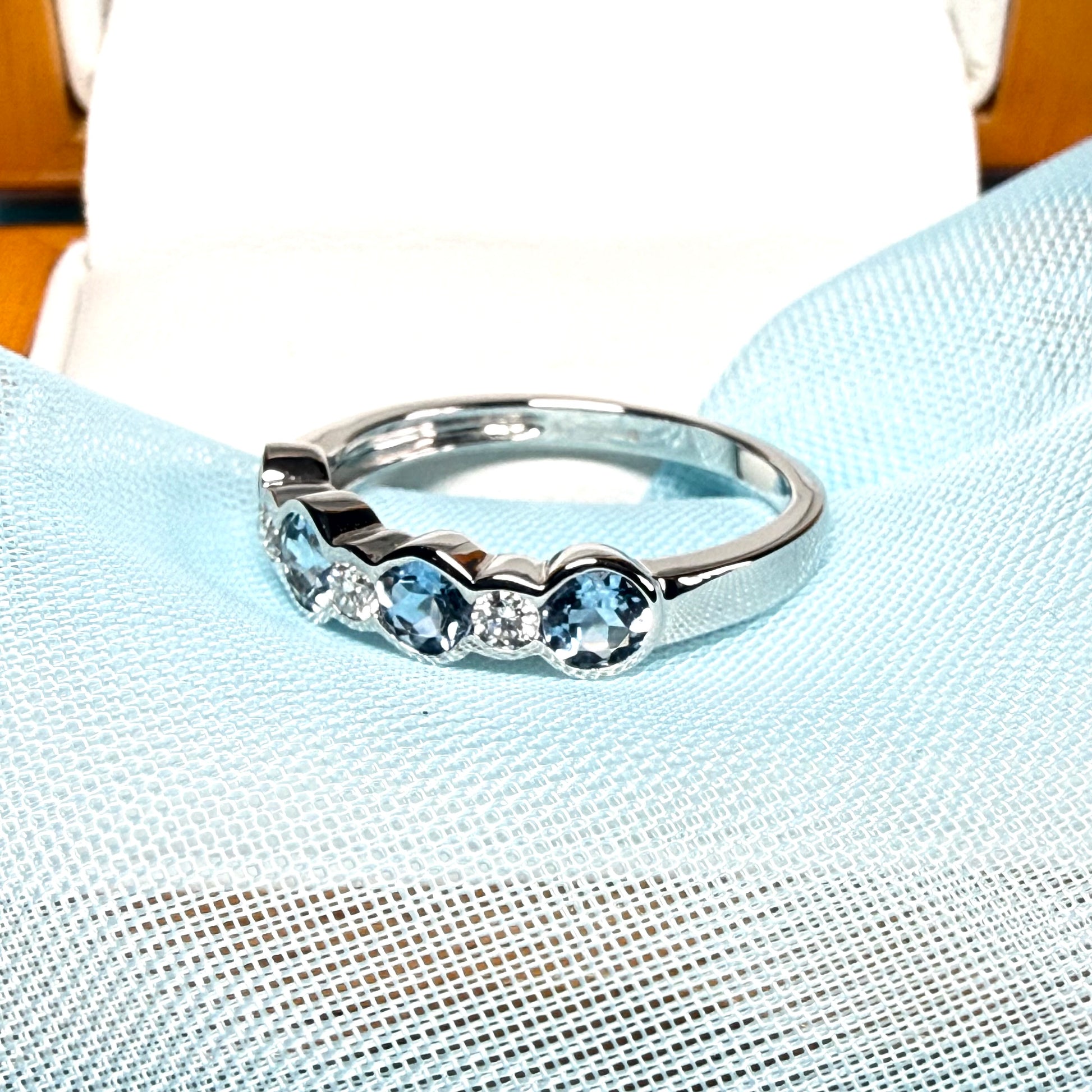 A real aquamarine and diamond white gold eternity ring