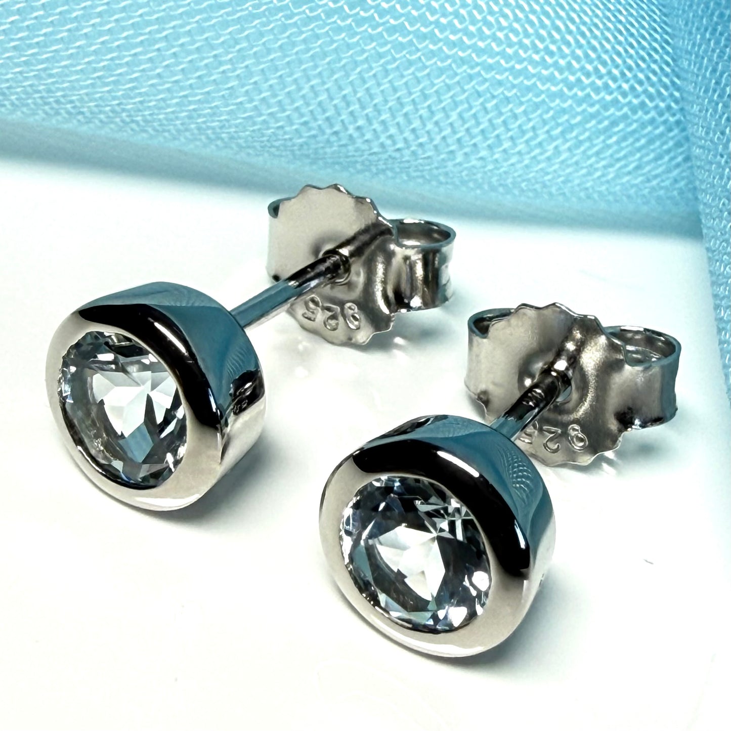 Real blue topaz round stud earrings smooth rubbed over edges