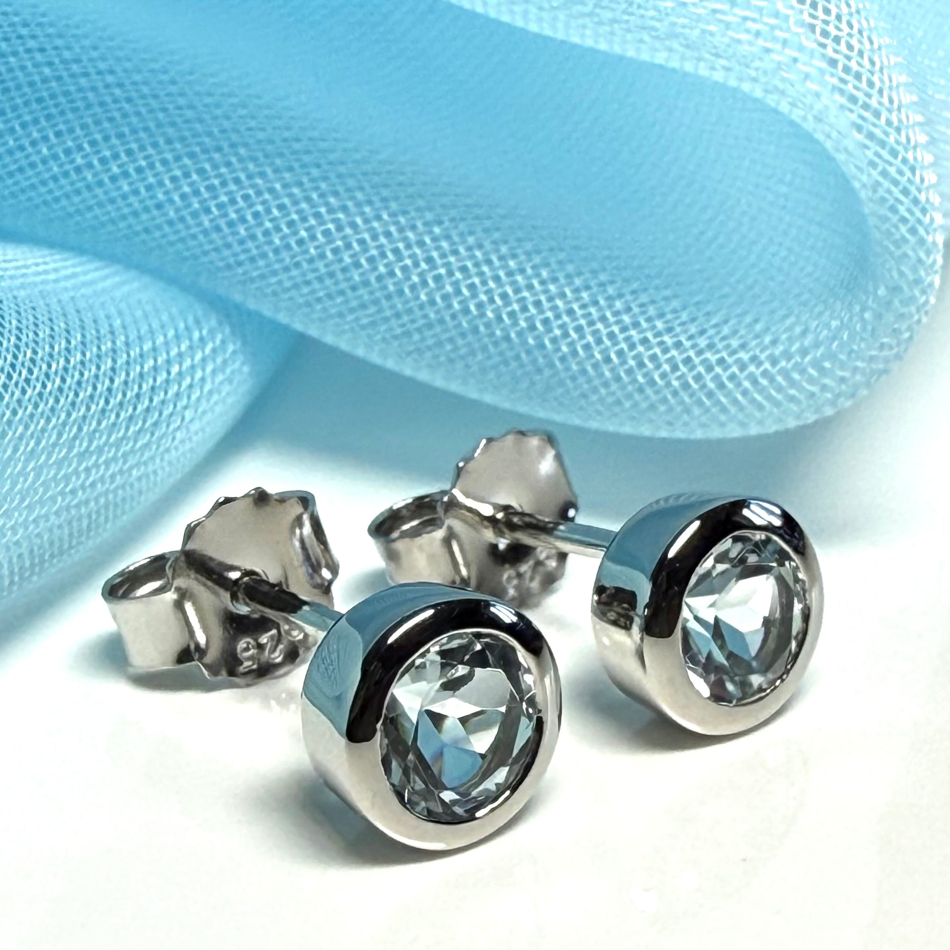 Real blue topaz round stud earrings smooth rubbed over edges