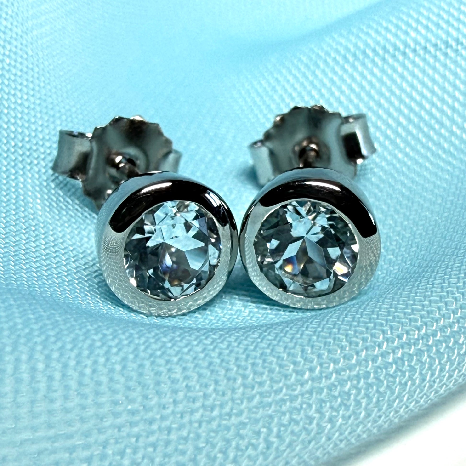 Real blue topaz round stud earrings smooth rubbed over edges
