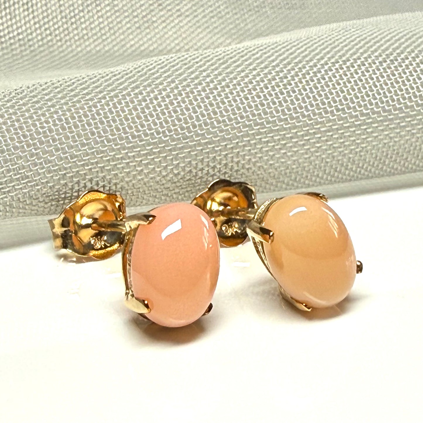 Real coral oval stud earrings yellow gold within a simple four claw setting