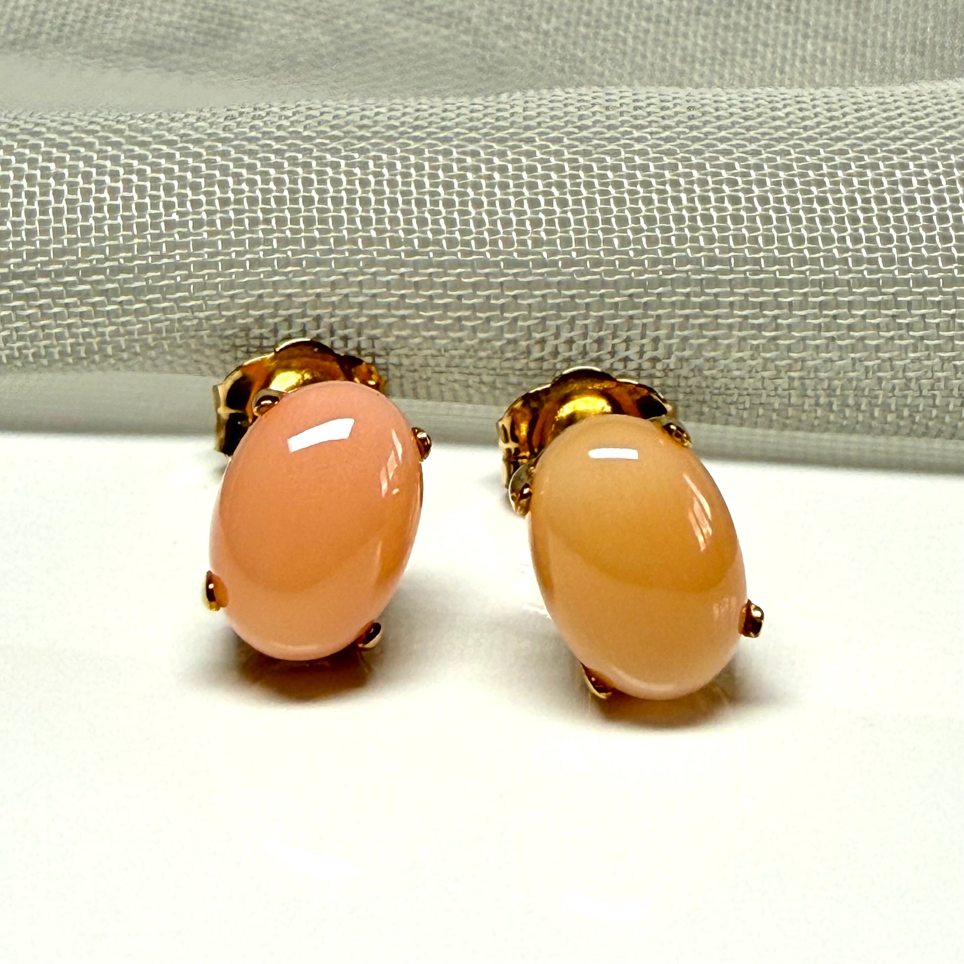 Real coral oval stud earrings yellow gold within a simple four claw setting