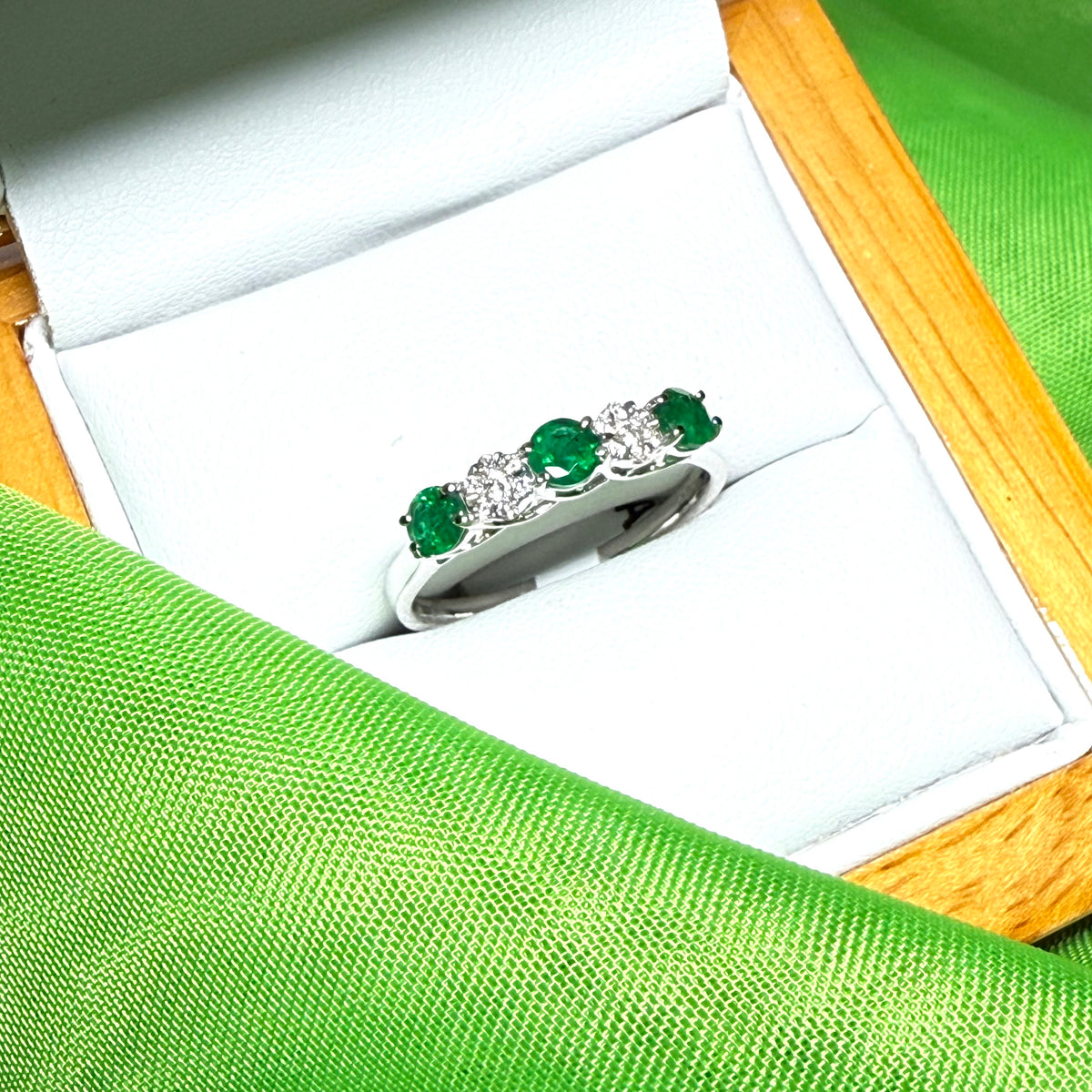Real emerald and diamond white gold eternity ring claw setting
