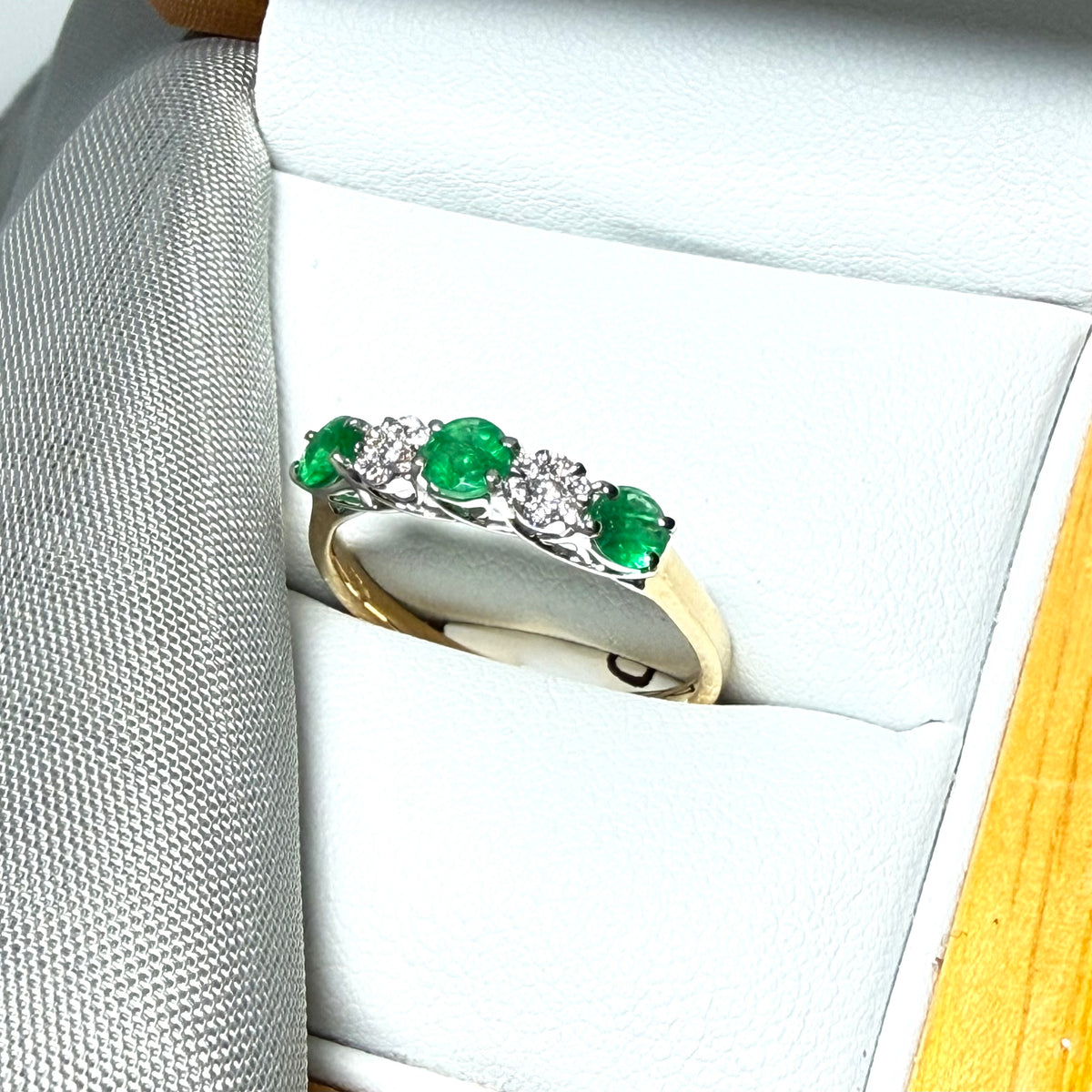 Real emerald and diamond yellow gold eternity ring claw setting
