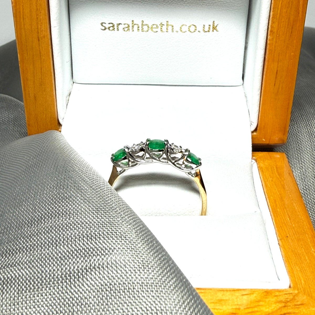 Real emerald and diamond yellow gold eternity ring claw setting