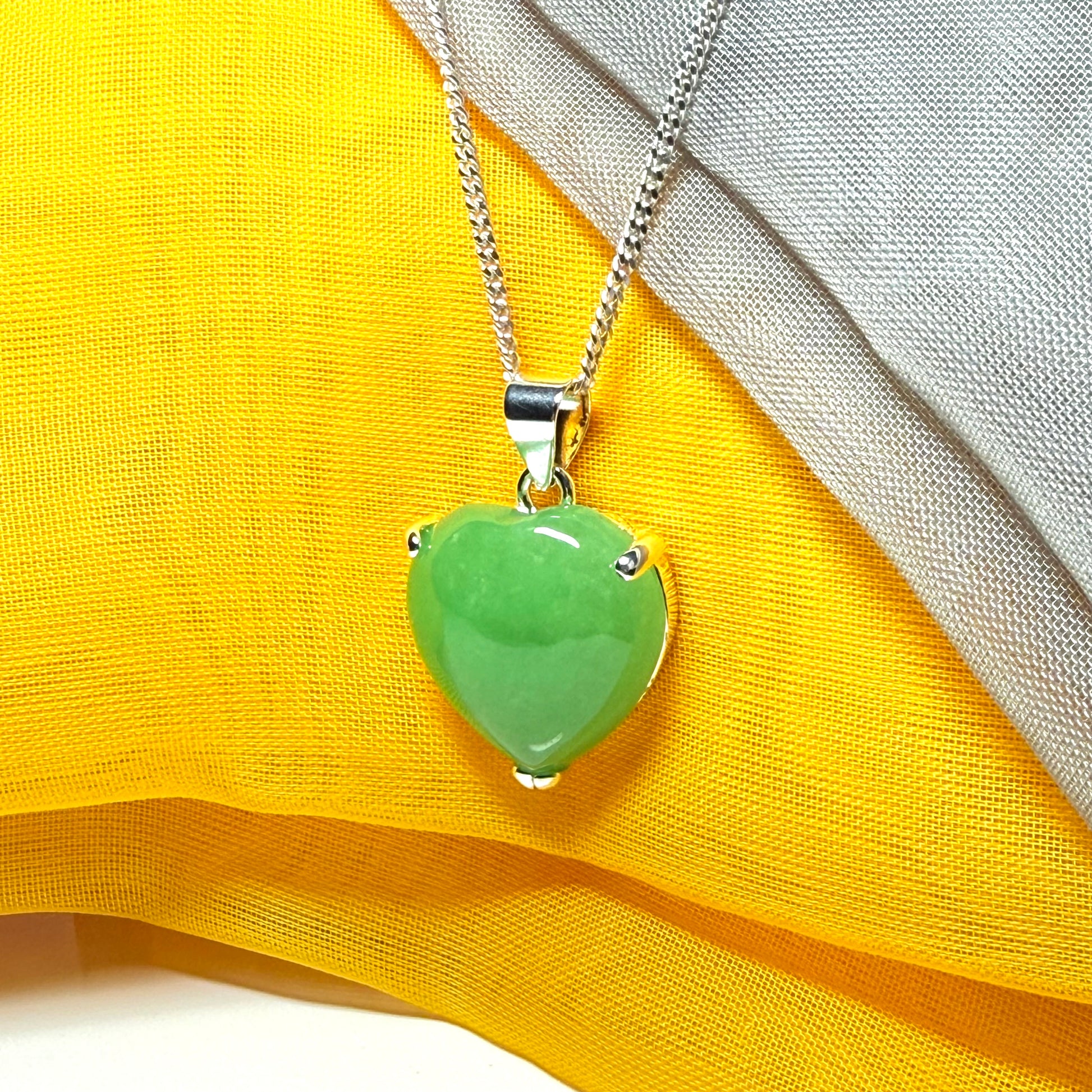 A real green jade necklace heart shaped sterling silver with chain included as well