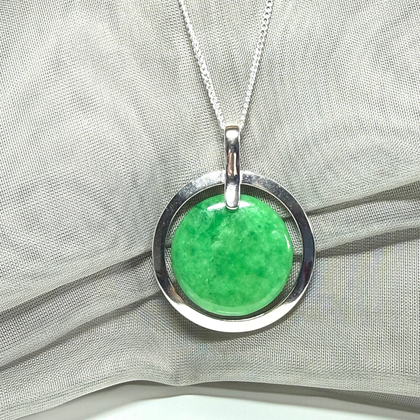 Real green jade necklace in a large round shape with a stunning designed halo pendant