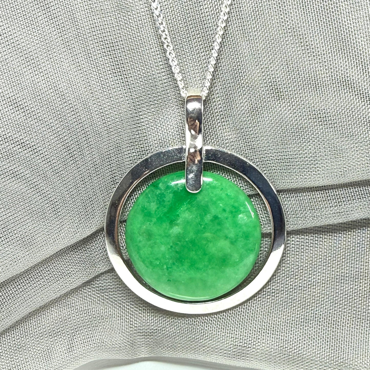Real green jade necklace in a large round shape with a stunning designed halo pendant