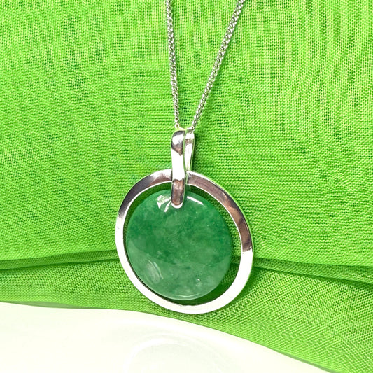 Real green jade necklace in a large round shape with a beautiful designed halo pendant, with whispers of green