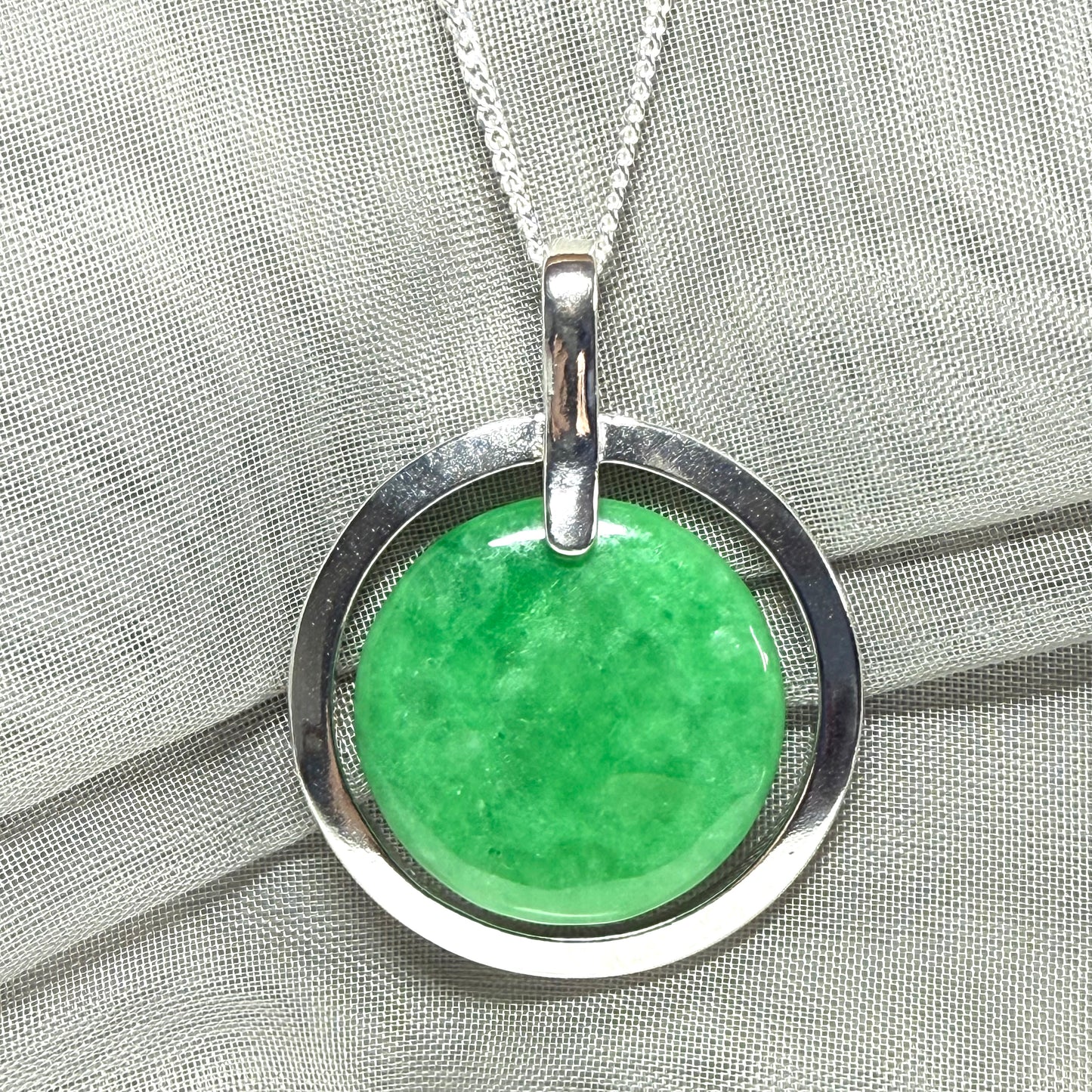 Real green jade necklace in a large round shape with a stunning designed halo pendant