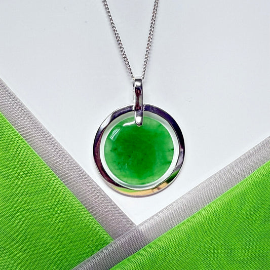 Real green jade necklace in a large round shaped halo pendant design