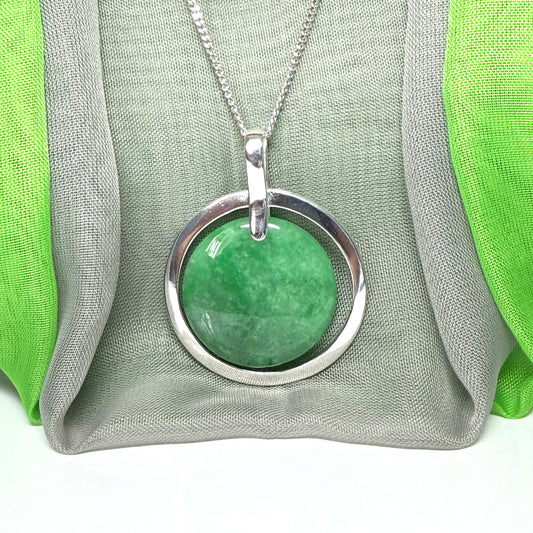 Real green jade necklace in a large round shaped pendant with a halo design