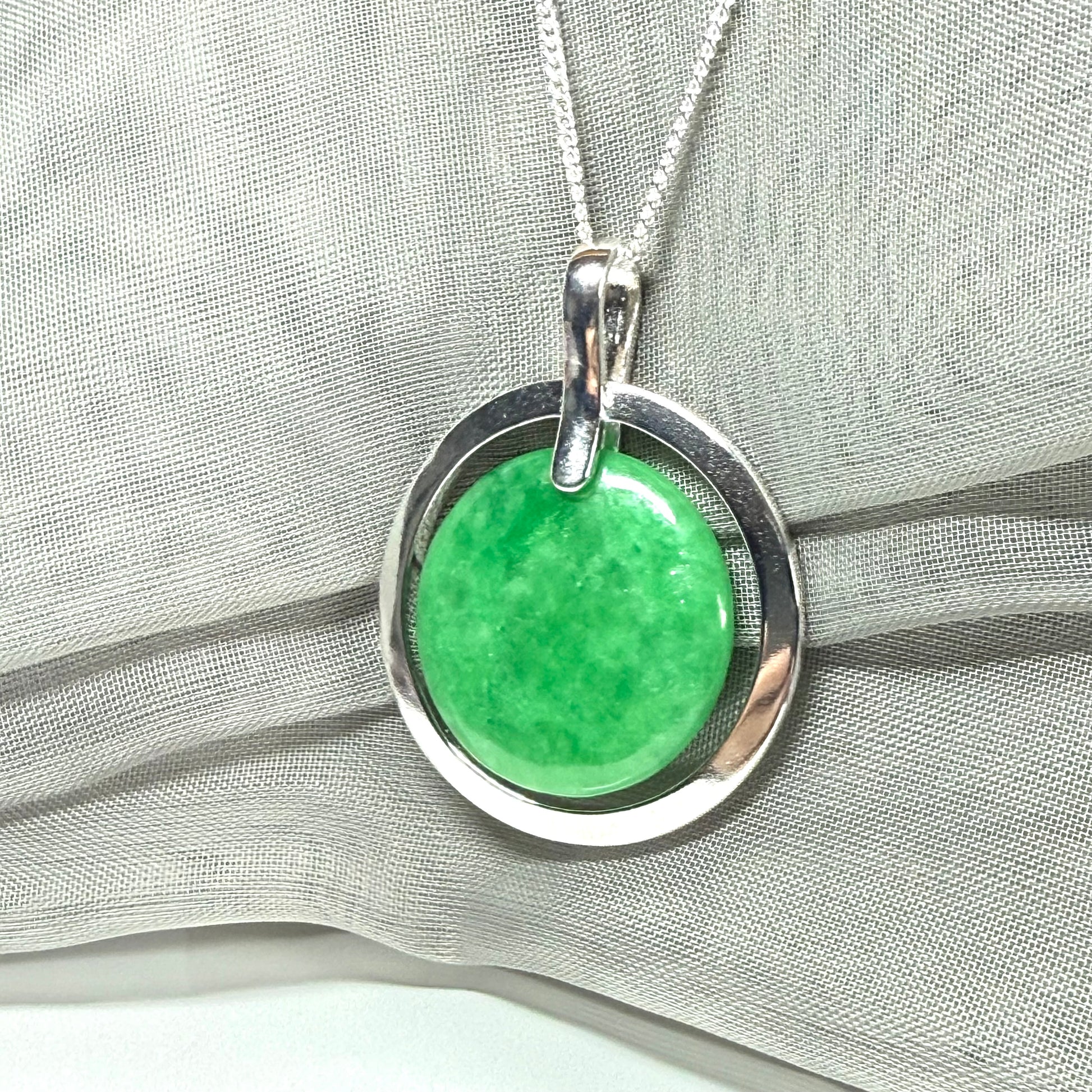 Real green jade necklace in a large round shape with a stunning designed halo pendant