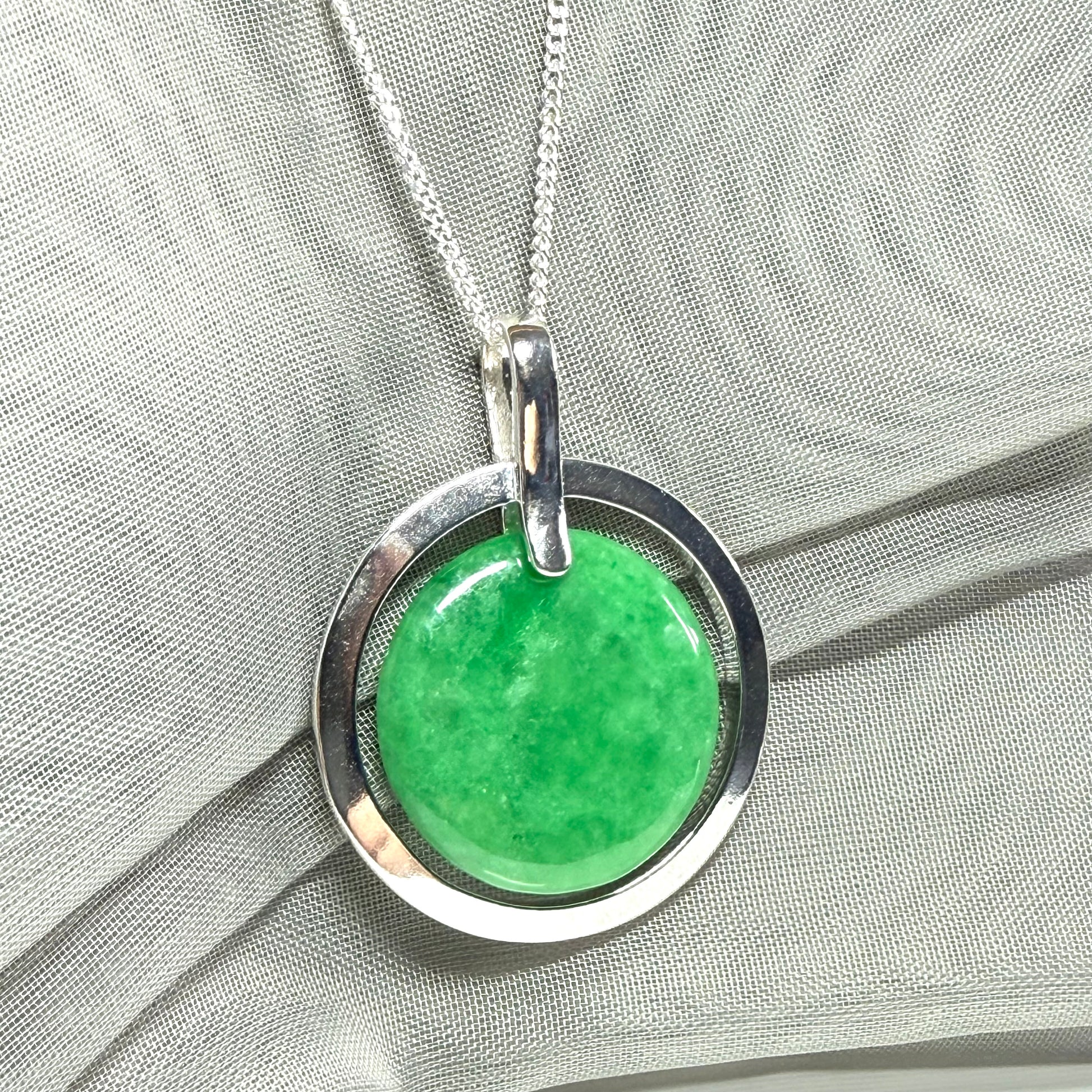 Real green jade necklace in a large round shape with a stunning designed halo pendant