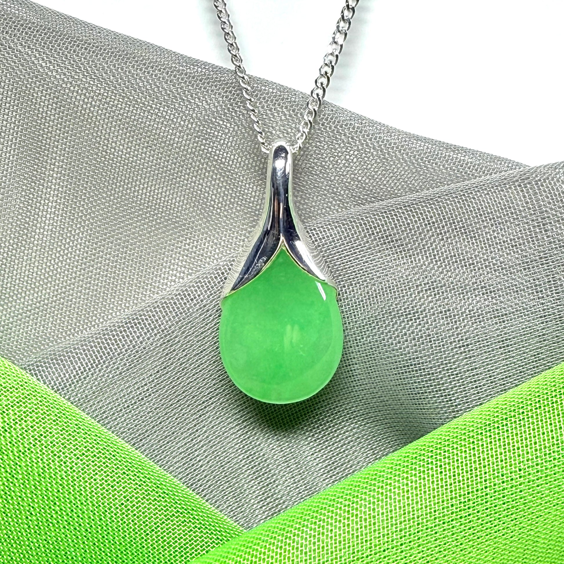 Real green jade necklace in a teardrop or pear shaped, timeless designed pendant with chain