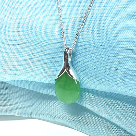 A real green jade necklace in a tear drop or pear shaped with a chain