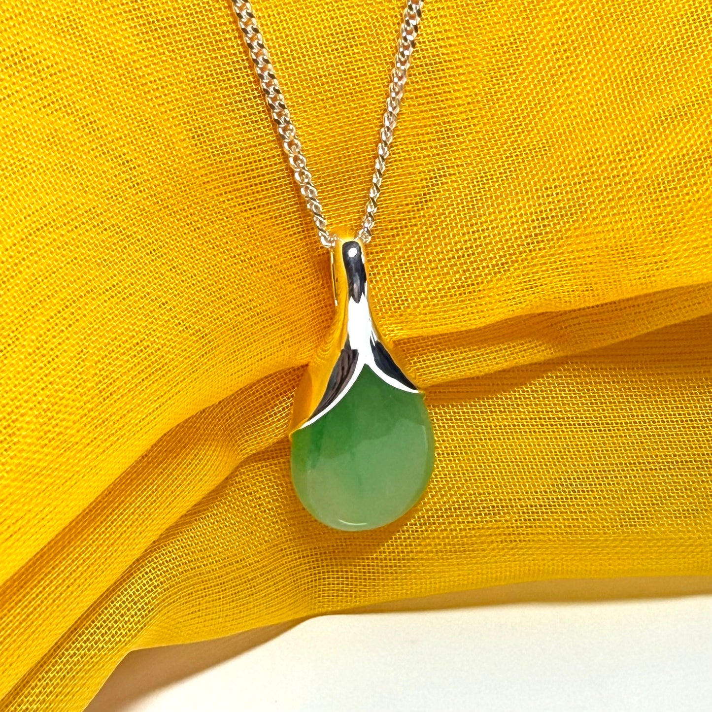 Real green jade necklace in a teardrop or pear shape, a really meaningful designed pendant with chain