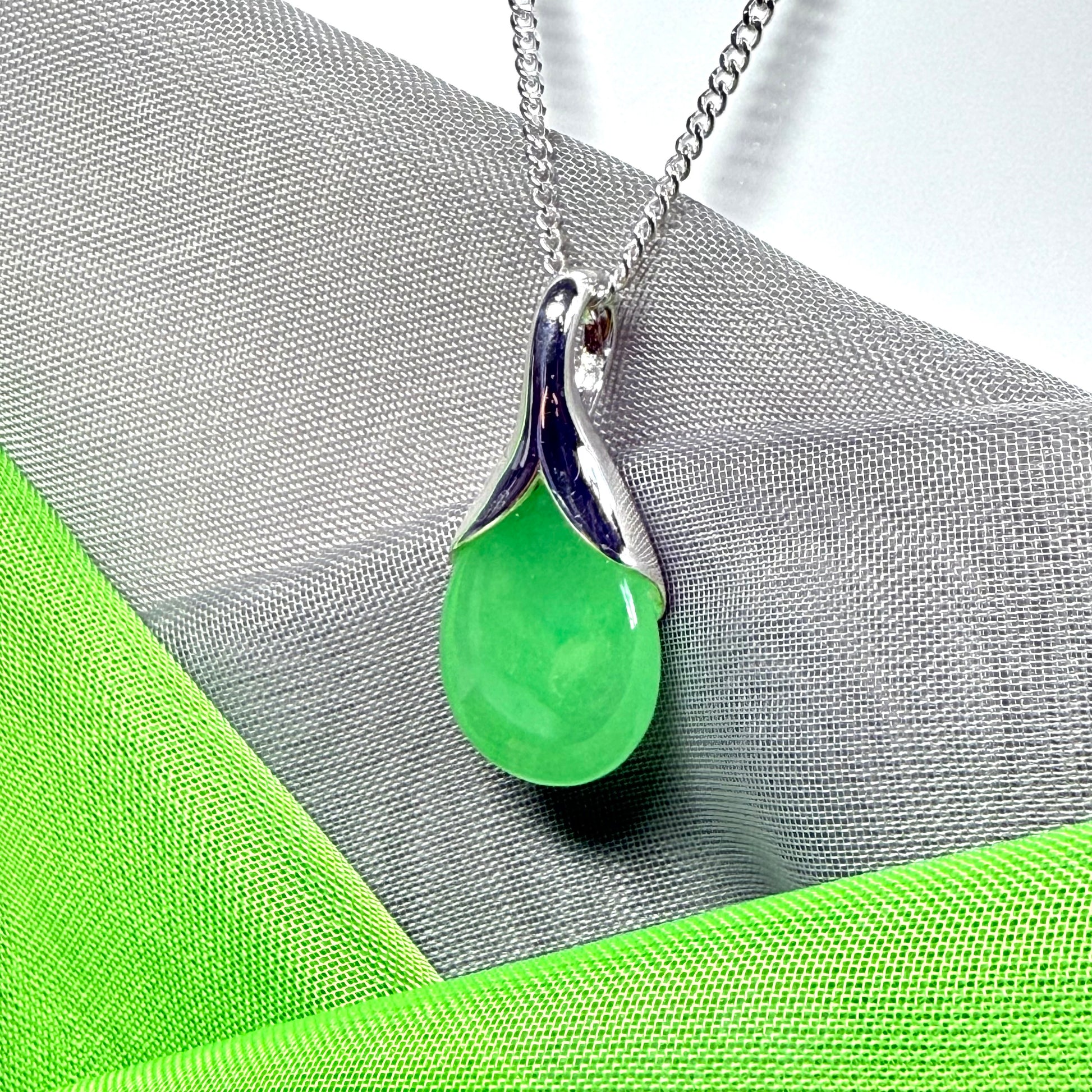 Real green jade necklace in a teardrop or pear shaped, timeless designed pendant with chain