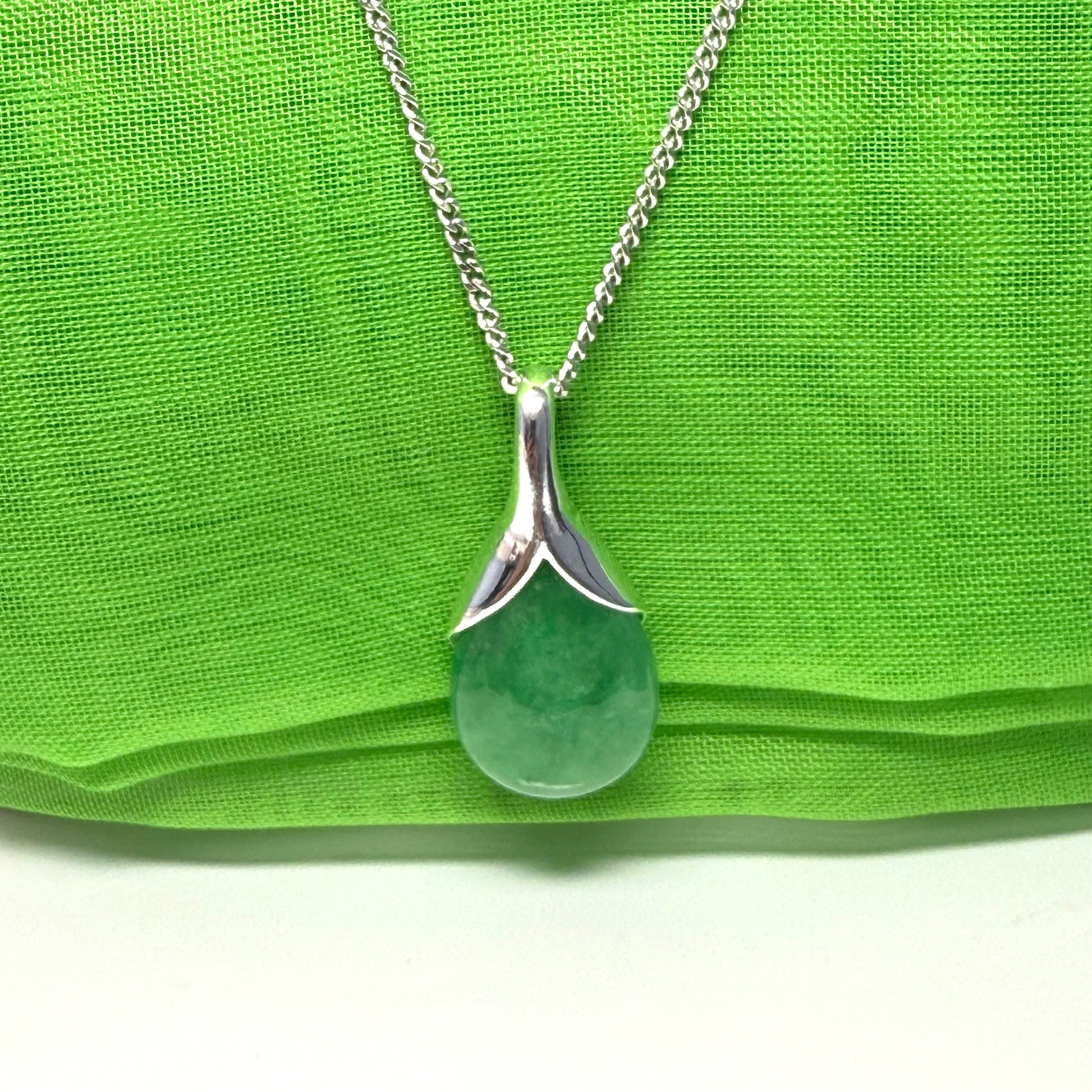 Real green jade necklace in a teardrop or pear shaped, a timeless designed pendant with a chain