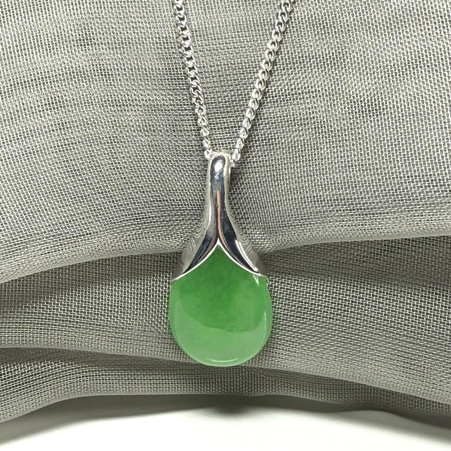 Real green jade necklace in a teardrop or pear shaped, timeless designed pendant solid chain