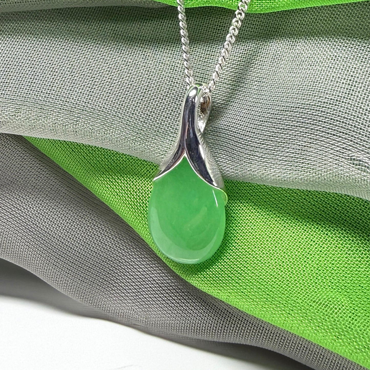 Real green jade necklace in a teardrop or pear shaped, timeless designed pendant with chain